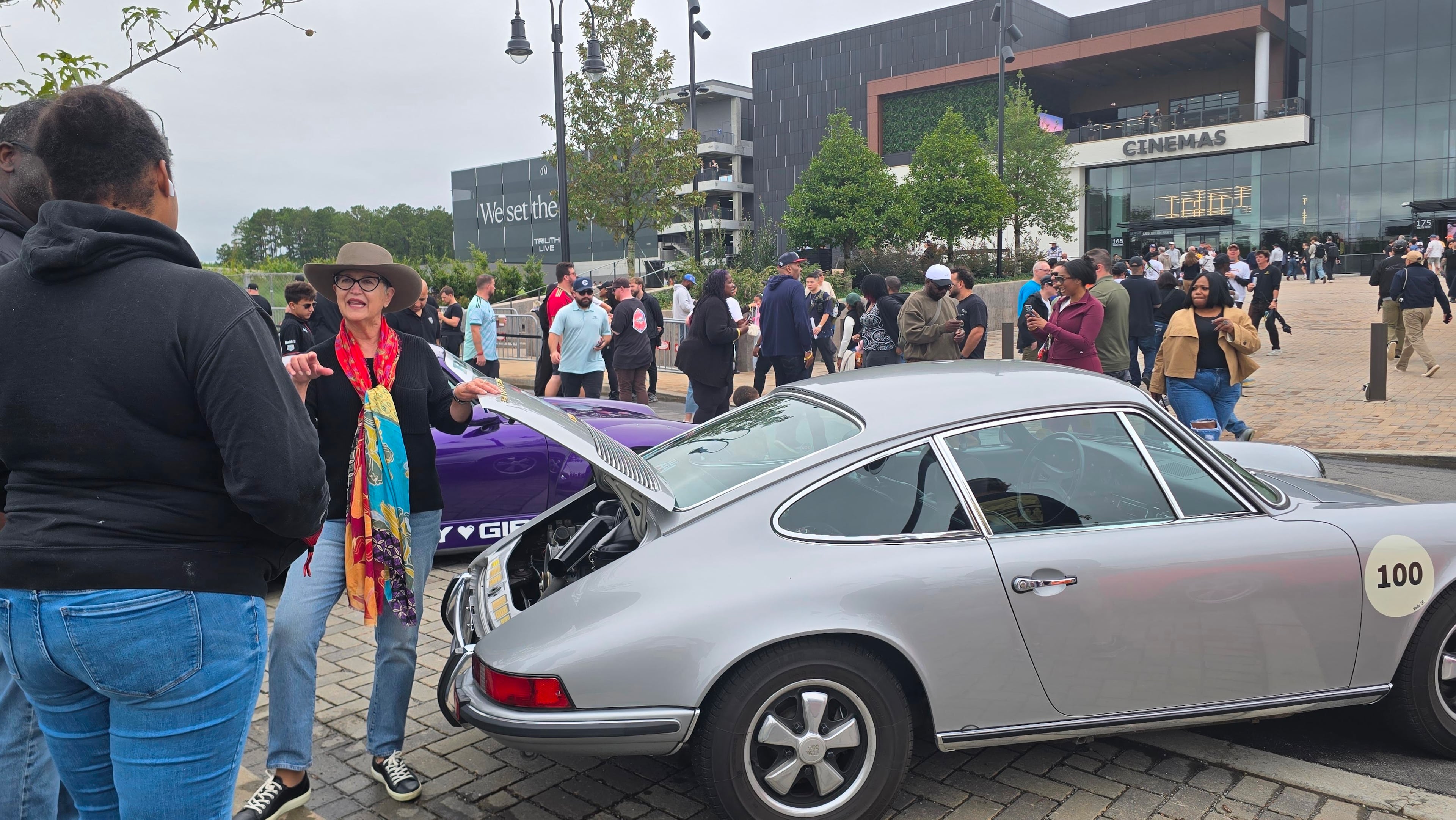 Pamela Brundage of Illinois talks with Luftgekühlt 12 attendees next to her 1970 Porsche 911T “longhood” coupe at Town at Trilith near Fayetteville, on Oct. 10, 2026. (Chris Hardesty/Cox Automotive)