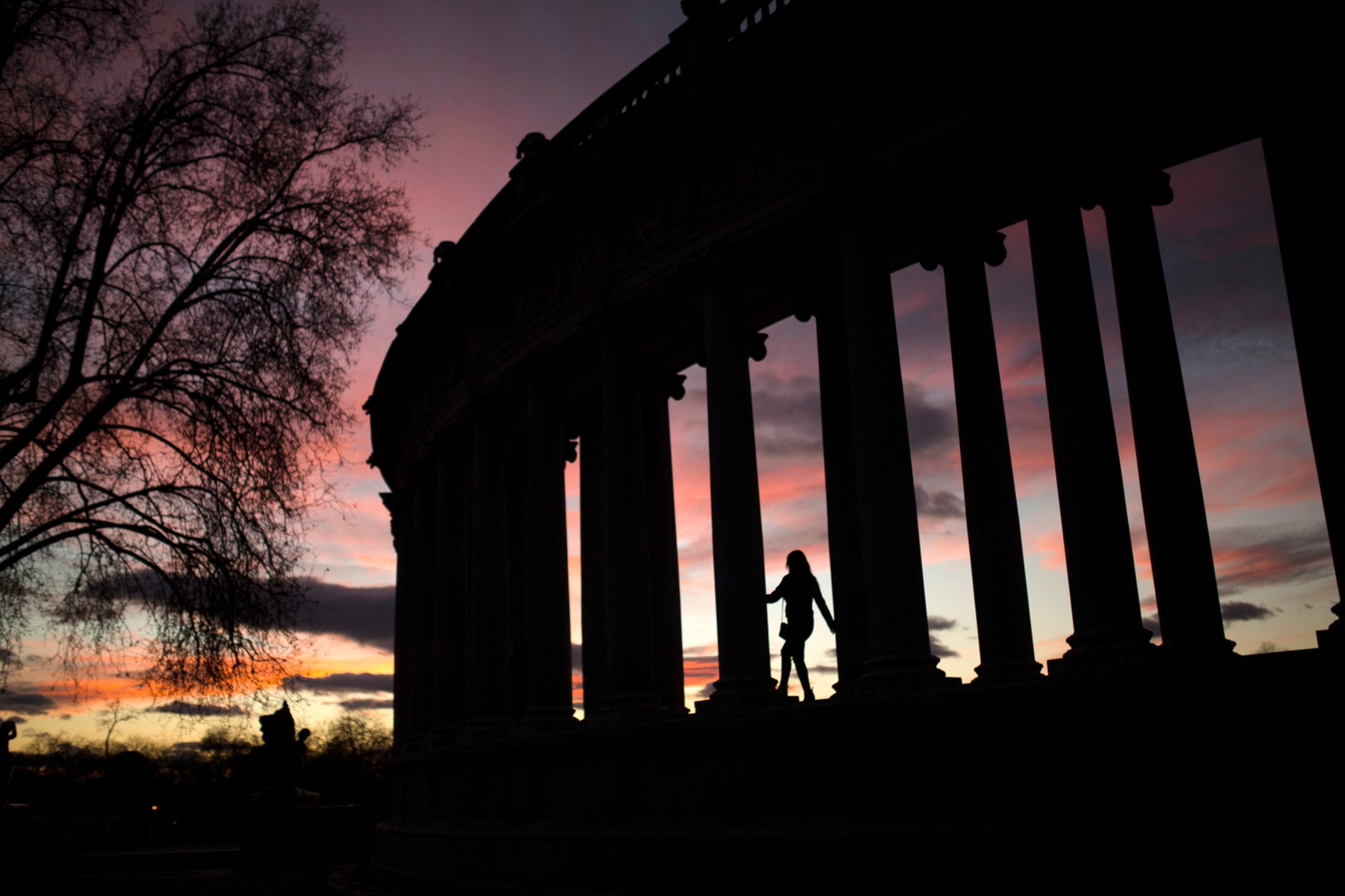 A woman walks among columns as she poses for photographs at the Retiro park in Madrid, Saturday, Jan. 14, 2017. (AP Photo/Francisco Seco)