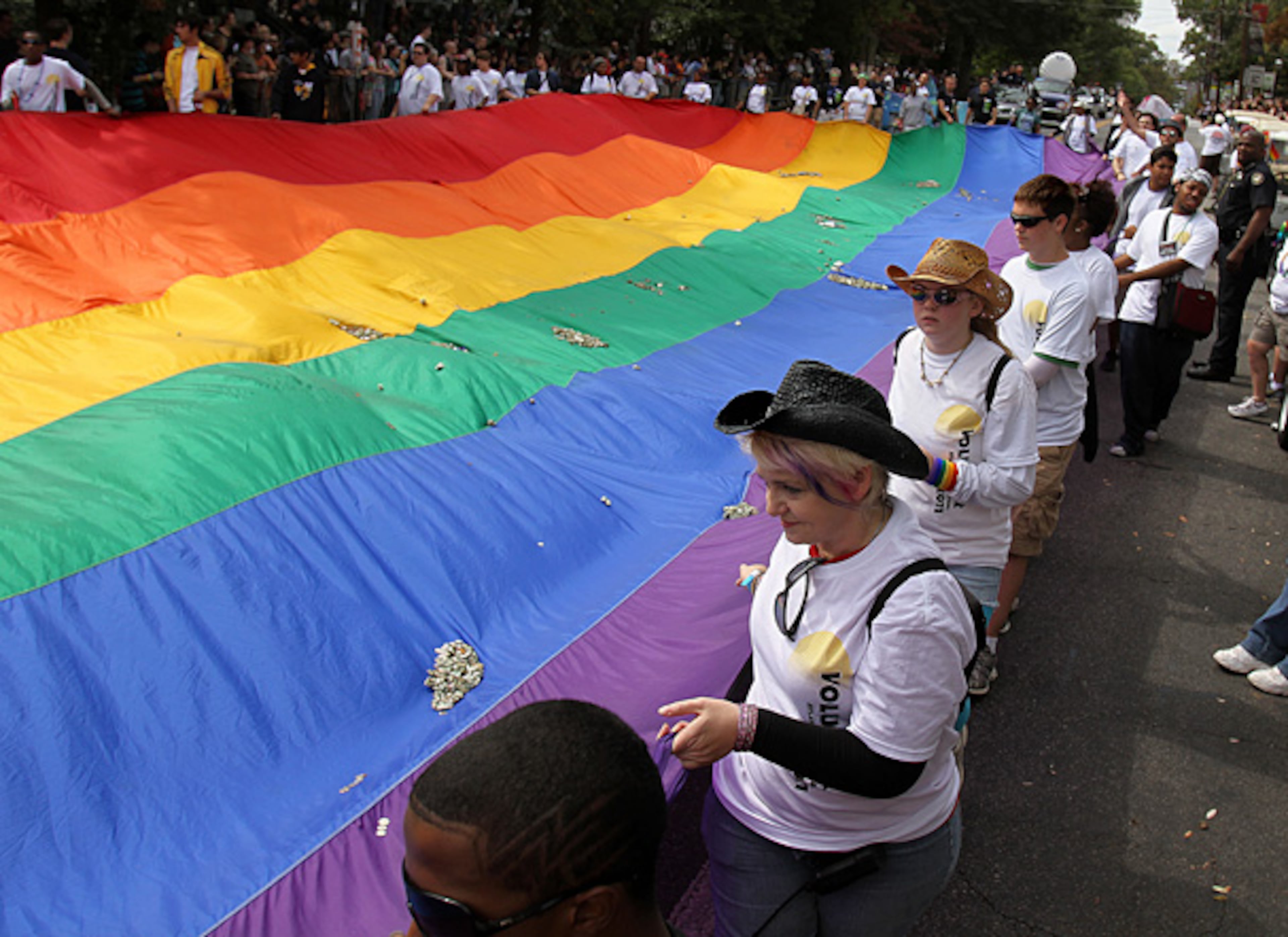 111019 Atlanta - The Rainbow flag makes its way along Piedmont Road as spectators drops donations during the 41st Atlanta Pride Parade at Piedmont Park Sunday, October 9, 2011. Vino Wong vwong@ajc.com