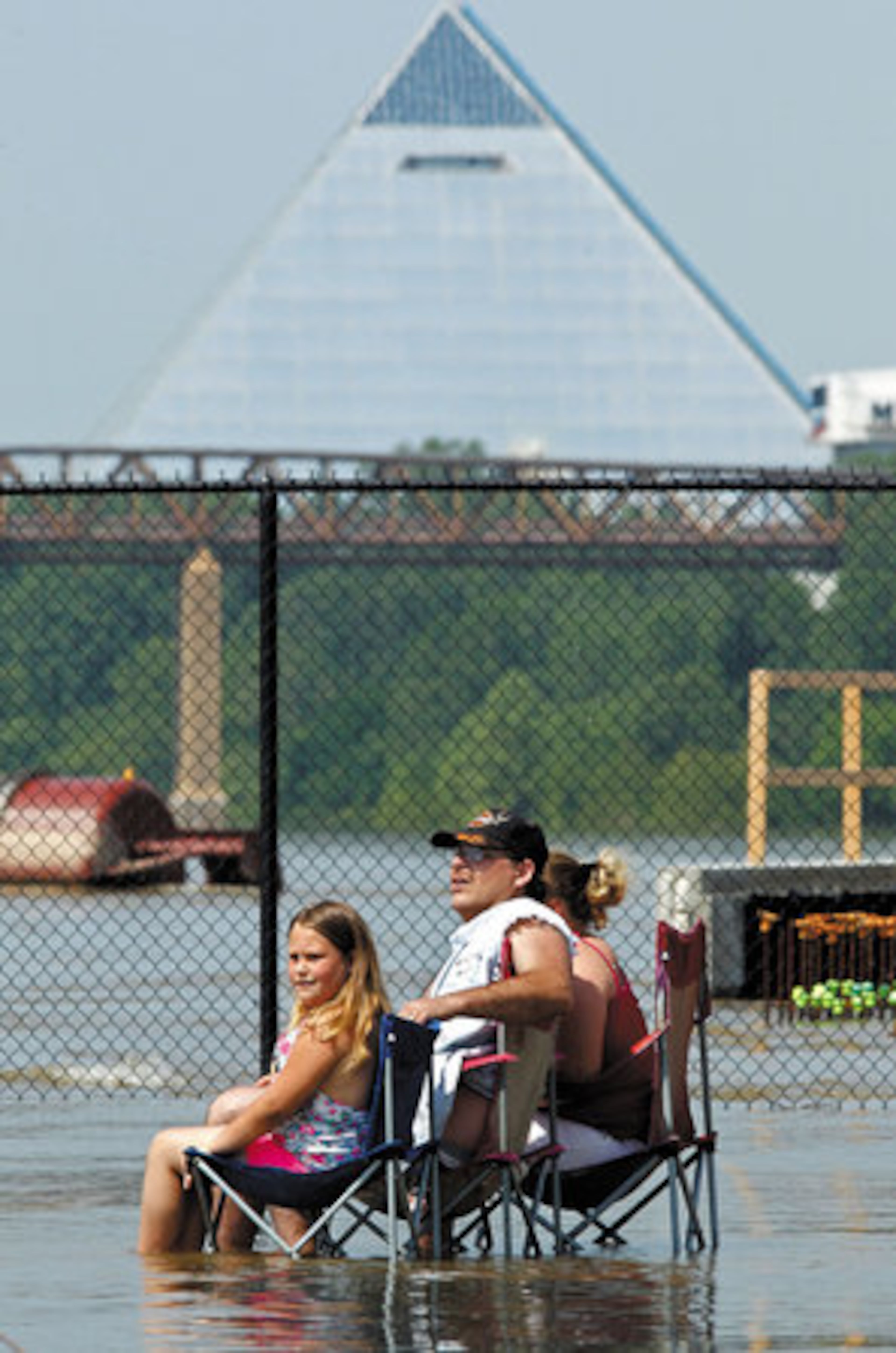 Robert and Carrie Medders and their daughter, Aleigha, 6 (left), take advantage of the swollen Mississippi River floodwaters to cool off on Tuesday in Memphis.