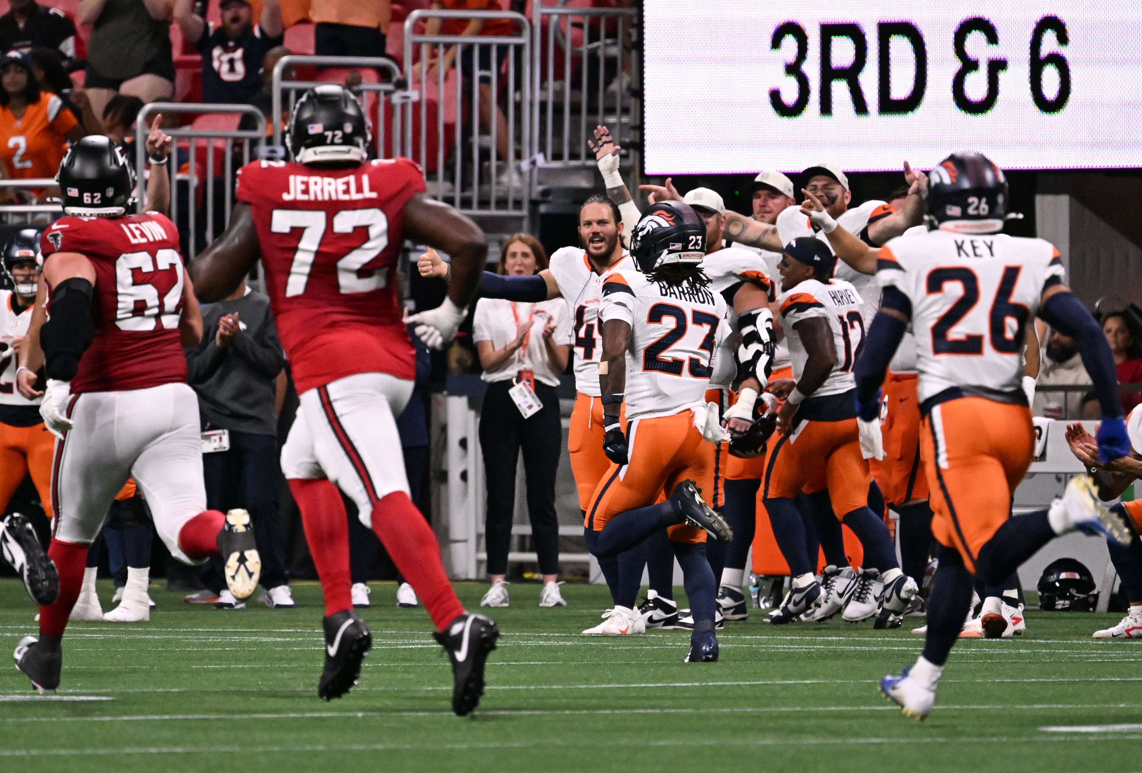 Broncos cornerback Jahdae Barron (center) runs for a touchdown after intercepting the ball during their preseason game against the Falcons at Mercedes-Benz Stadium on Friday, Aug. 14, 2026, in Atlanta. (Hyosub Shin/AJC)