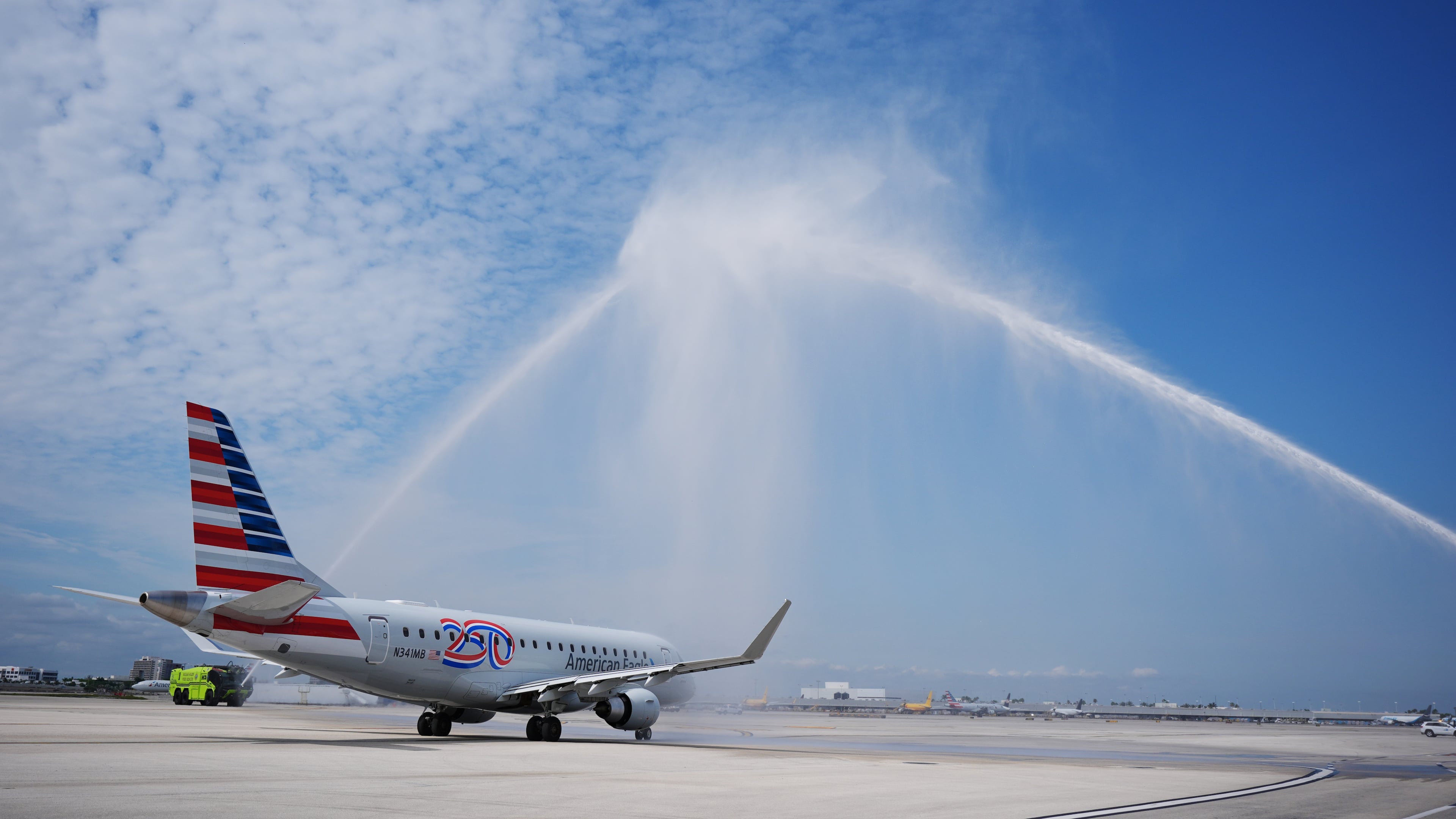 American Airlines Flight AA3599, the first direct commercial flight between the United States and Venezuela in seven years, gets a water cannon salute as it taxis away from the gate, Thursday, April 30, 2026, at Miami International Airport in Miami. (AP Photo/Rebecca Blackwell)