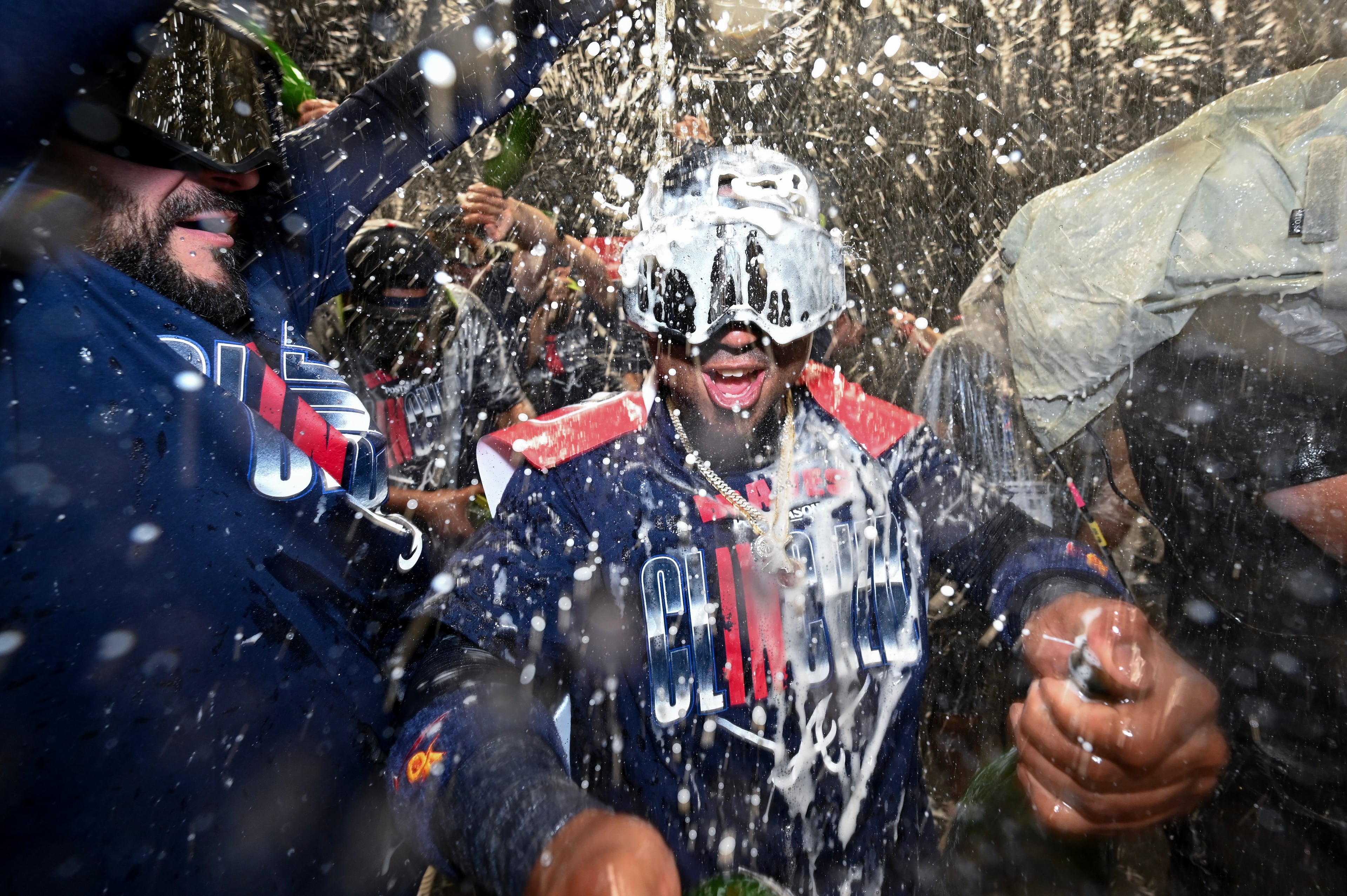 Ozzie Albies enjoys a champagne shower as he and teammates celebrate advancing to the NLDS. (Hyosub Shin/AJC)