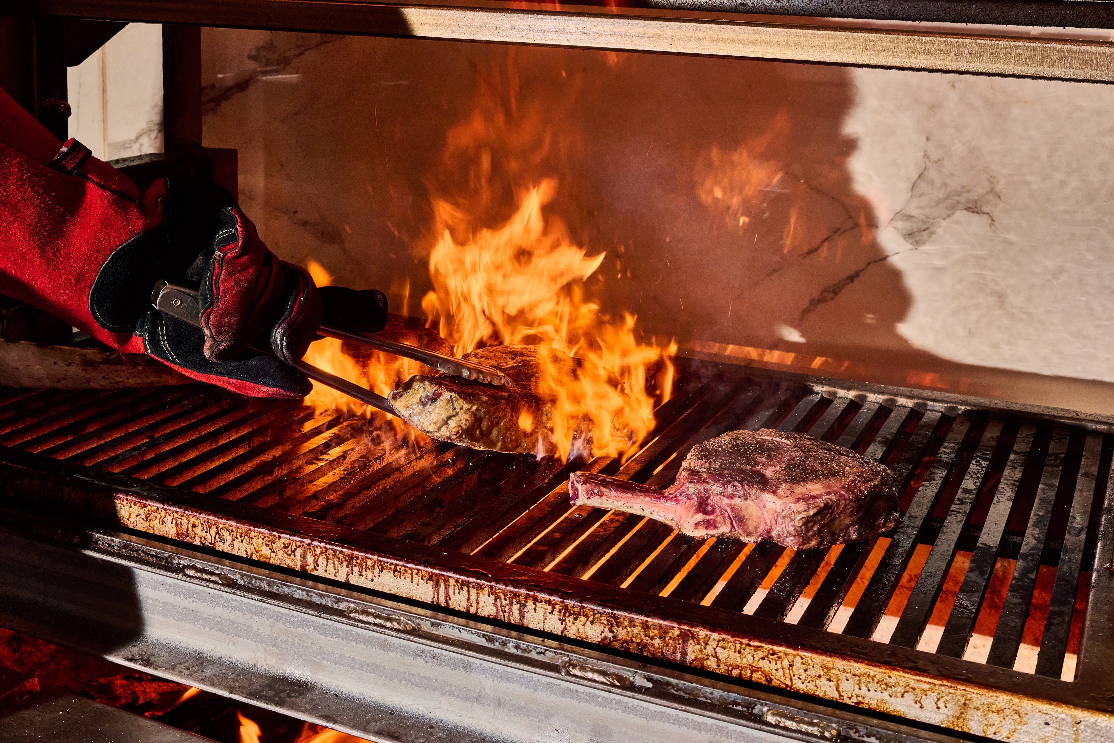 The steaks at Clark's Steakhouse are seared over a hickory-wood fire. (Angie Webb/Courtesy of Clark's Steakhouse)