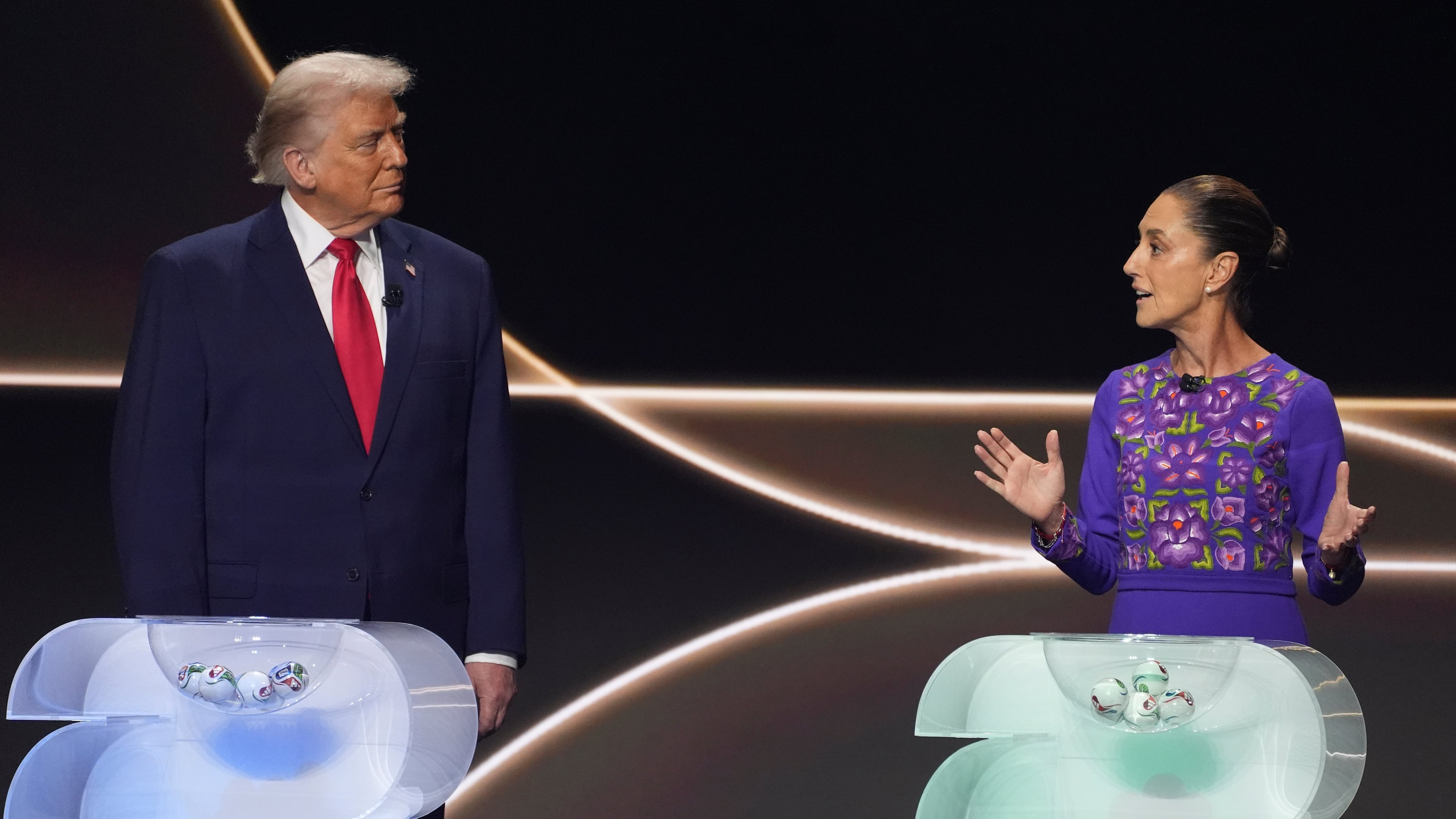 FILE -Mexican President Claudia Sheinbaum, right, speaks as President Donald Trump, left, stands on stage during the draw for the 2026 soccer World Cup at the Kennedy Center in Washington, Dec. 5, 2025. (AP Photo/Evan Vucci, File)