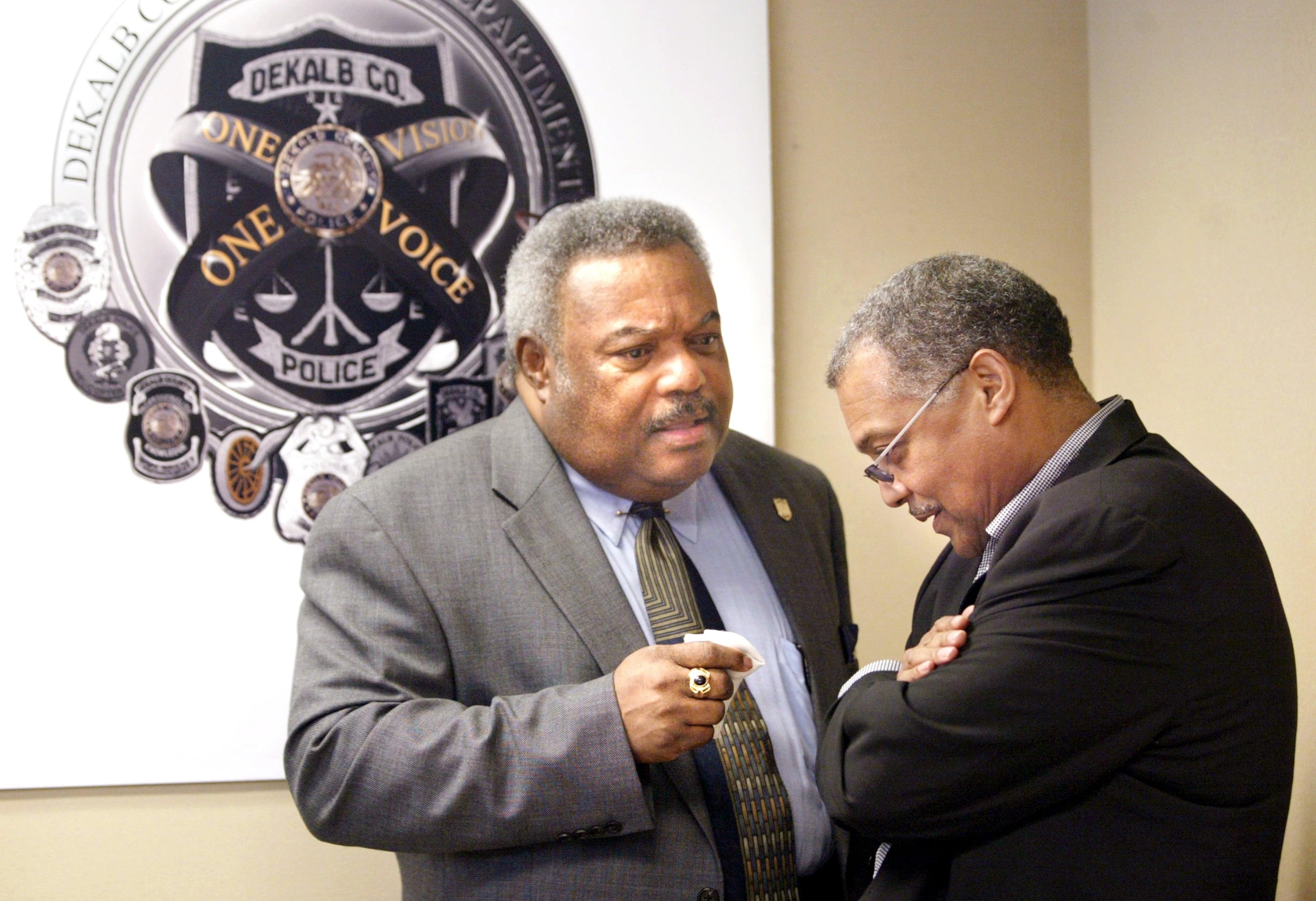 DeKalb County Chief of Police Louis Graham, left, has a quiet conversation with Wayne Williams' attorney, Lynn Whatley, right, of Whatley, Stephenson, Voles, LLC law office after a news conference Wednesday, May 11, 2005 introducing a cold case squad that will reinvestigate five unsolved murders. "Things are in motion now," Whatley said, "powerful evidentiary things are coming about." (JENNI GIRTMAN/AJC staff)