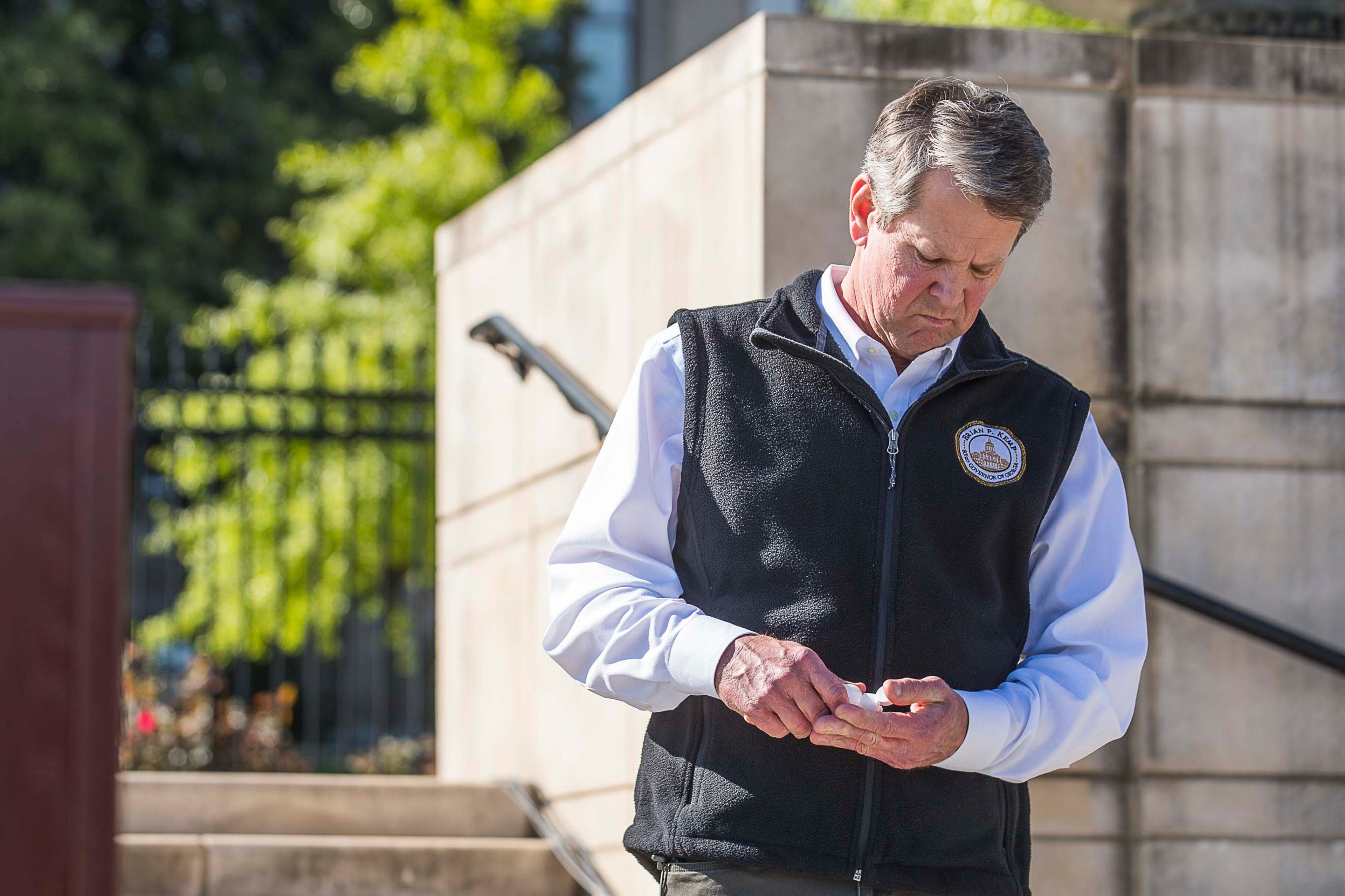 04/01/2020 - Atlanta, Georgia - Gov. Brian Kemp uses hand sanitizer to clean his hands during a press conference at Liberty Plaza, across the street from the Georgia State Capitol building, in downtown Atlanta, Wednesday, April 1, 2020. During the presser, Gov. Kemp ordered all Georgia K-12 schools to be closed until the end of the academic school year. He also said he will sign an order on Thursday forcing a "Stay-at-home" order for all Georgians until April 13. (ALYSSA POINTER / ALYSSA.POINTER@AJC.COM)