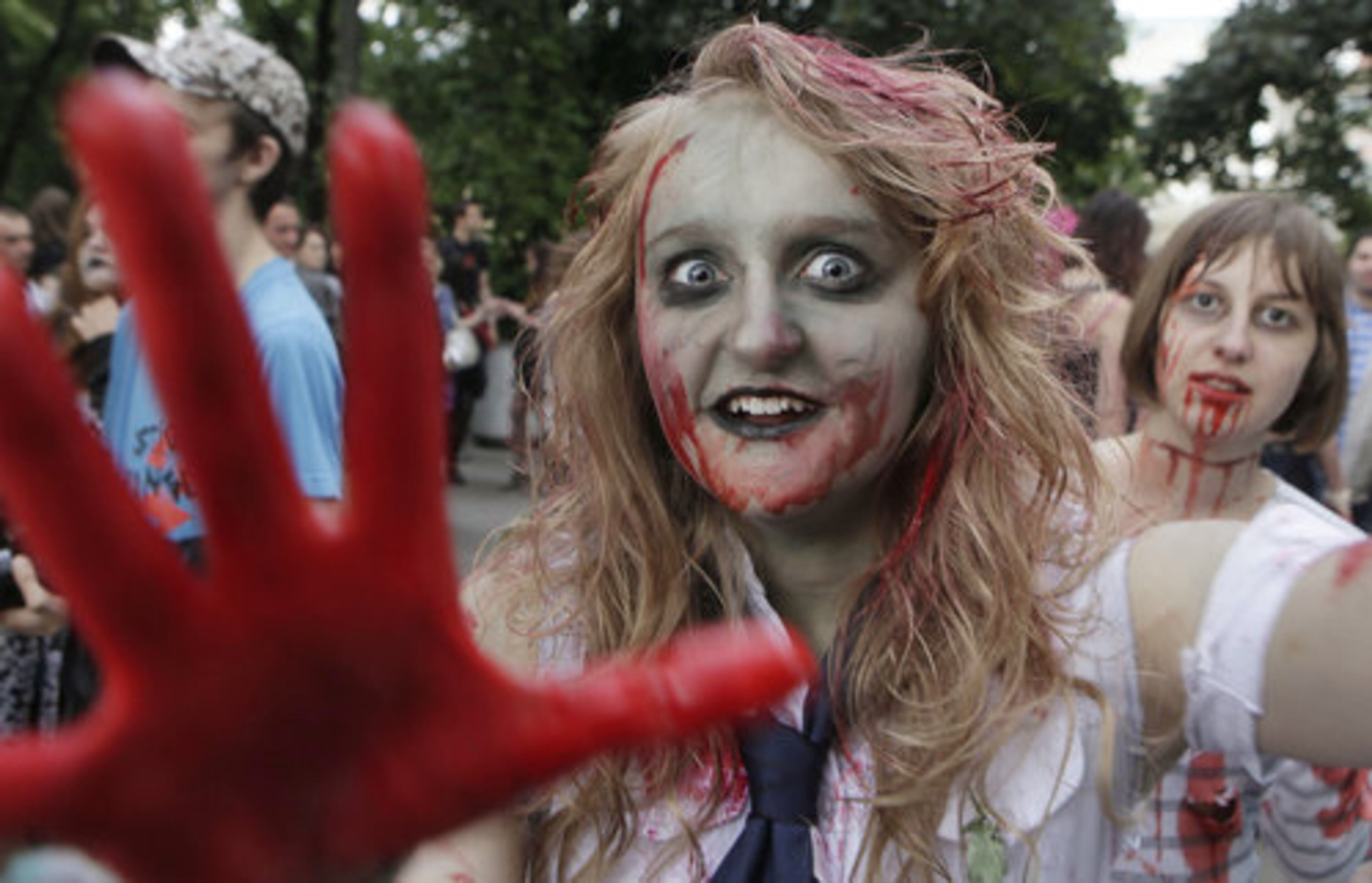A zombie mugs for the camera as she participates in a zombie parade in honor of Michael Jackson's 'Thriller' in Warsaw, Poland.