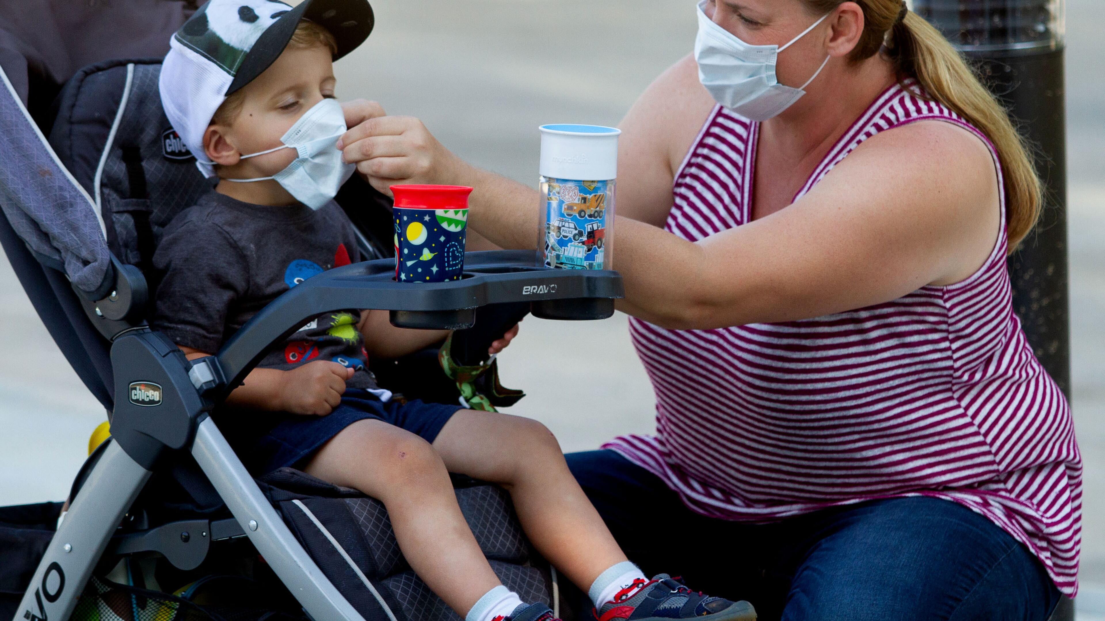 Marlie Arnold helps her son Lucas with his mask before entering the Atlanta zoo Saturday, May 16, 2020. STEVE SCHAEFER FOR THE ATLANTA JOURNAL-CONSTITUTION
