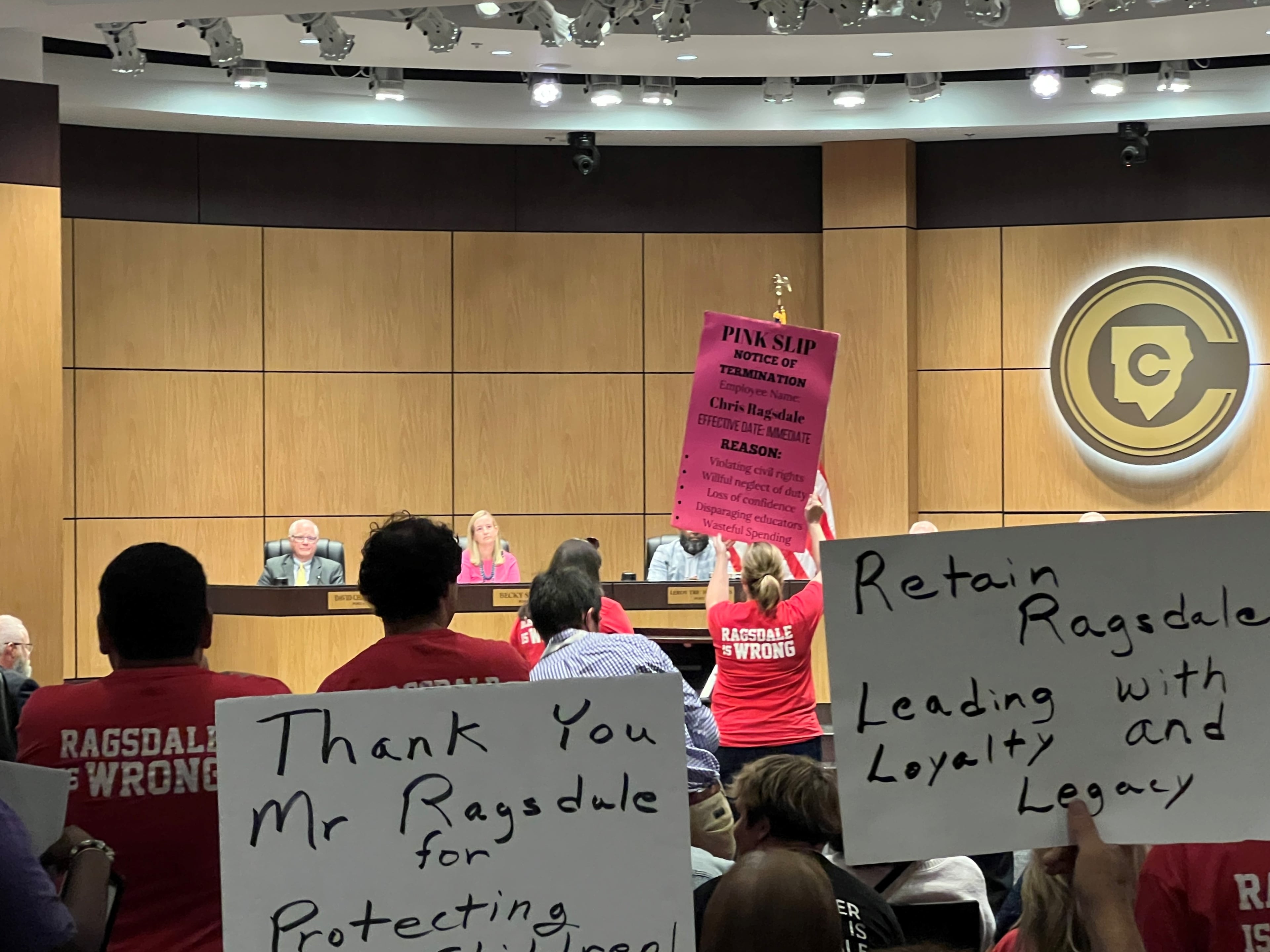 Some community members asked for the removal of Superintendent Chris Ragsdale at a school board meeting in 2023. Others held signs thanking him for his leadership. (Photo by Cassidy Alexander)
