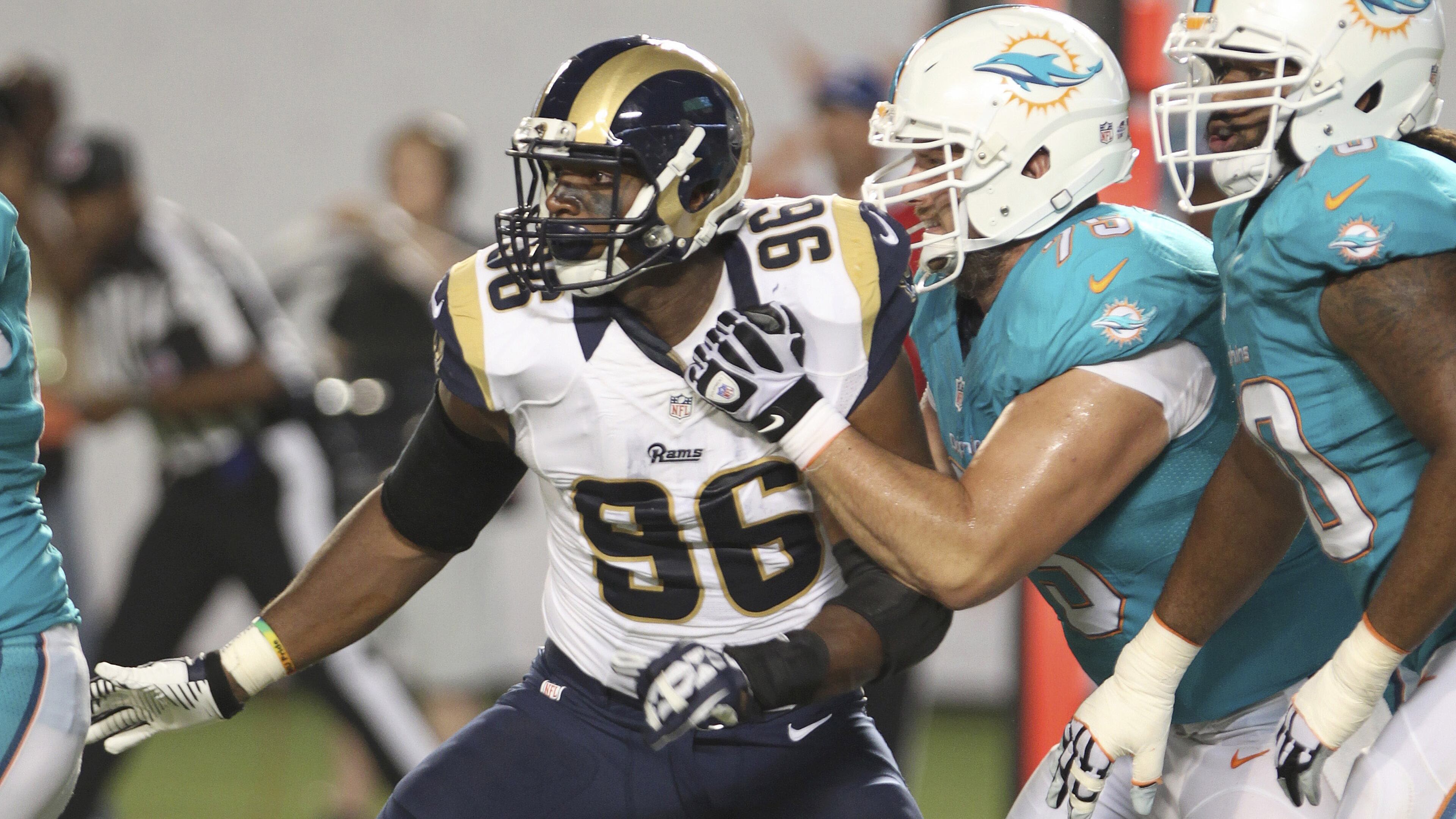 MIAMI GARDENS, FL - AUGUST 28: Defensive end Michael Sam #96 of the St. Louis Rams tries to elude Nate Garner #75 of the Miami Dolphins in the second quarter at Sun Life Stadium on August 28, 2014 in Miami Gardens, Florida. (Photo by Marc Serota/Getty Images) Michael Sam had three sacks in preseason but no team has signed him to its practice squad. (AP photo)