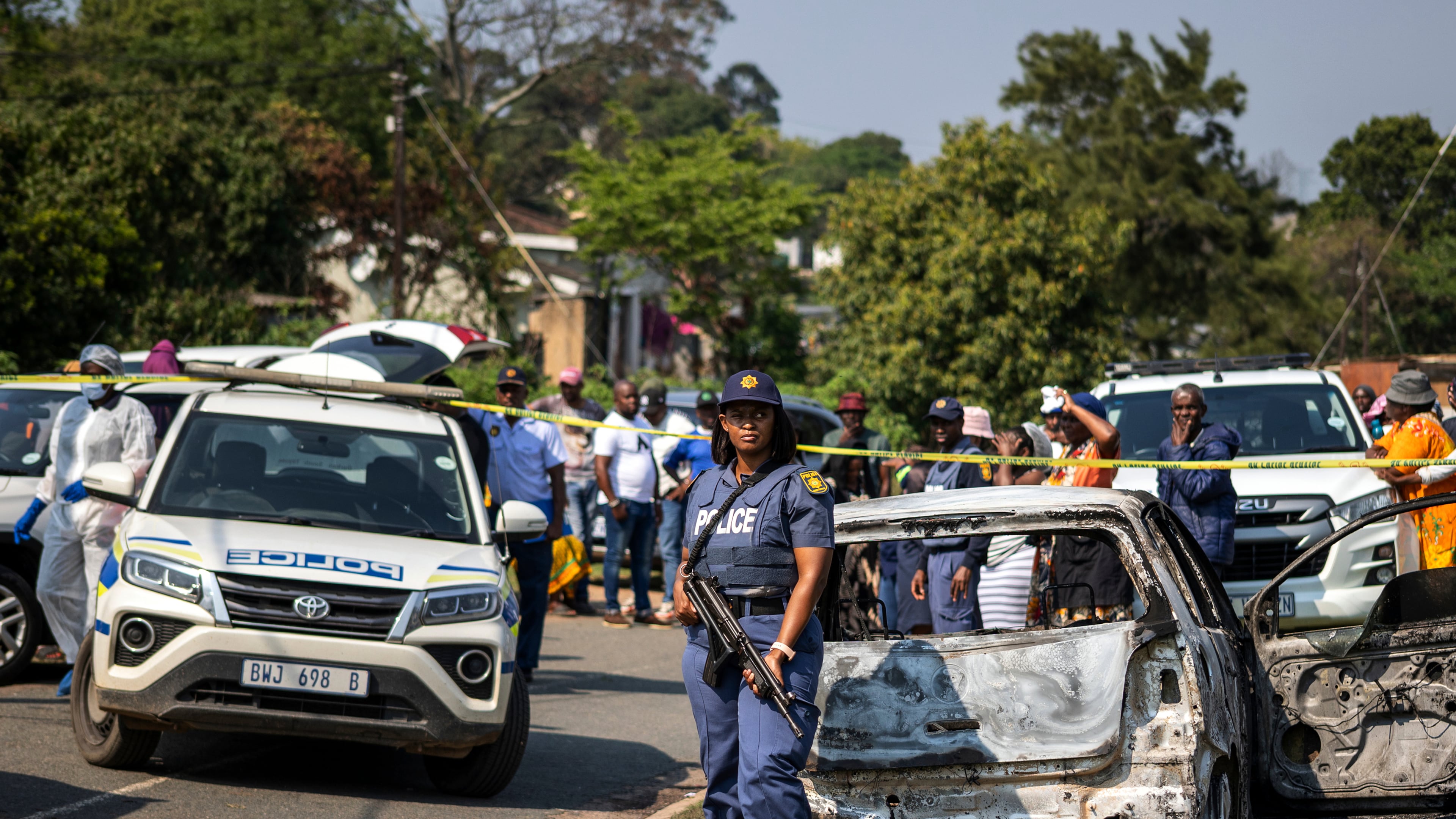 A police officer stands at the scene of a mass shooting at a house party in KwaMakhutha township south of the city of Durban, South Africa, Wednesday, Sept. 23, 2026. (AP Photo)