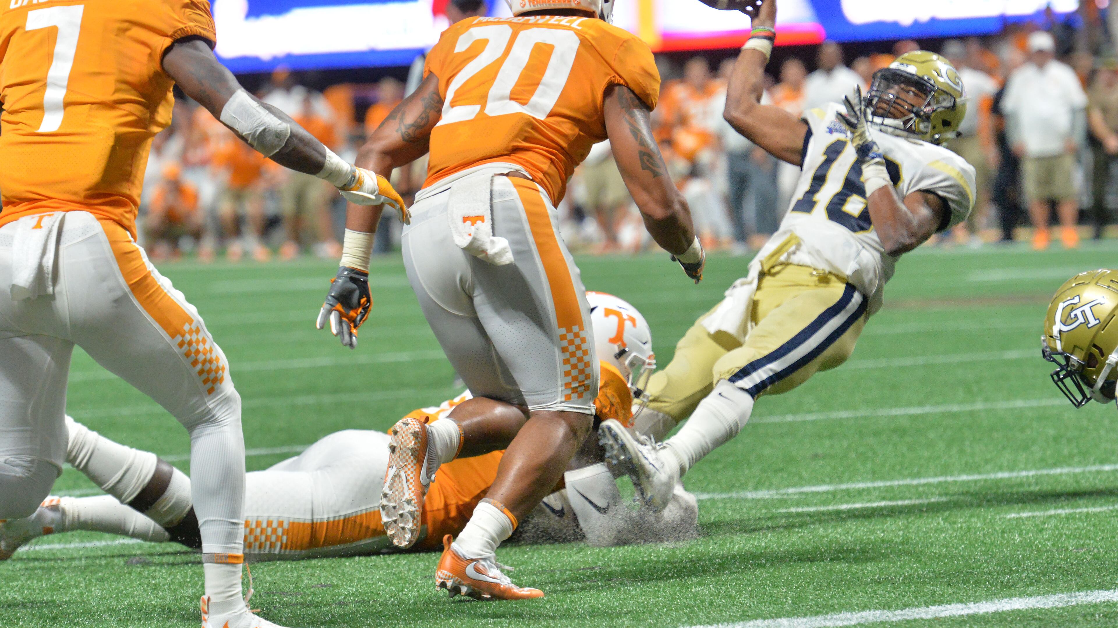 Georgia Tech quarterback TaQuon Marshall (16) attempts to make a pitch on the final play of Monday's Chick-fil-A Kickoff game at Mercedes-Benz Stadium. Tennessee stopped the Jackets on the play to preserve the 42-41 double overtime victory. Hyosub Shin/hshin@ajc.com