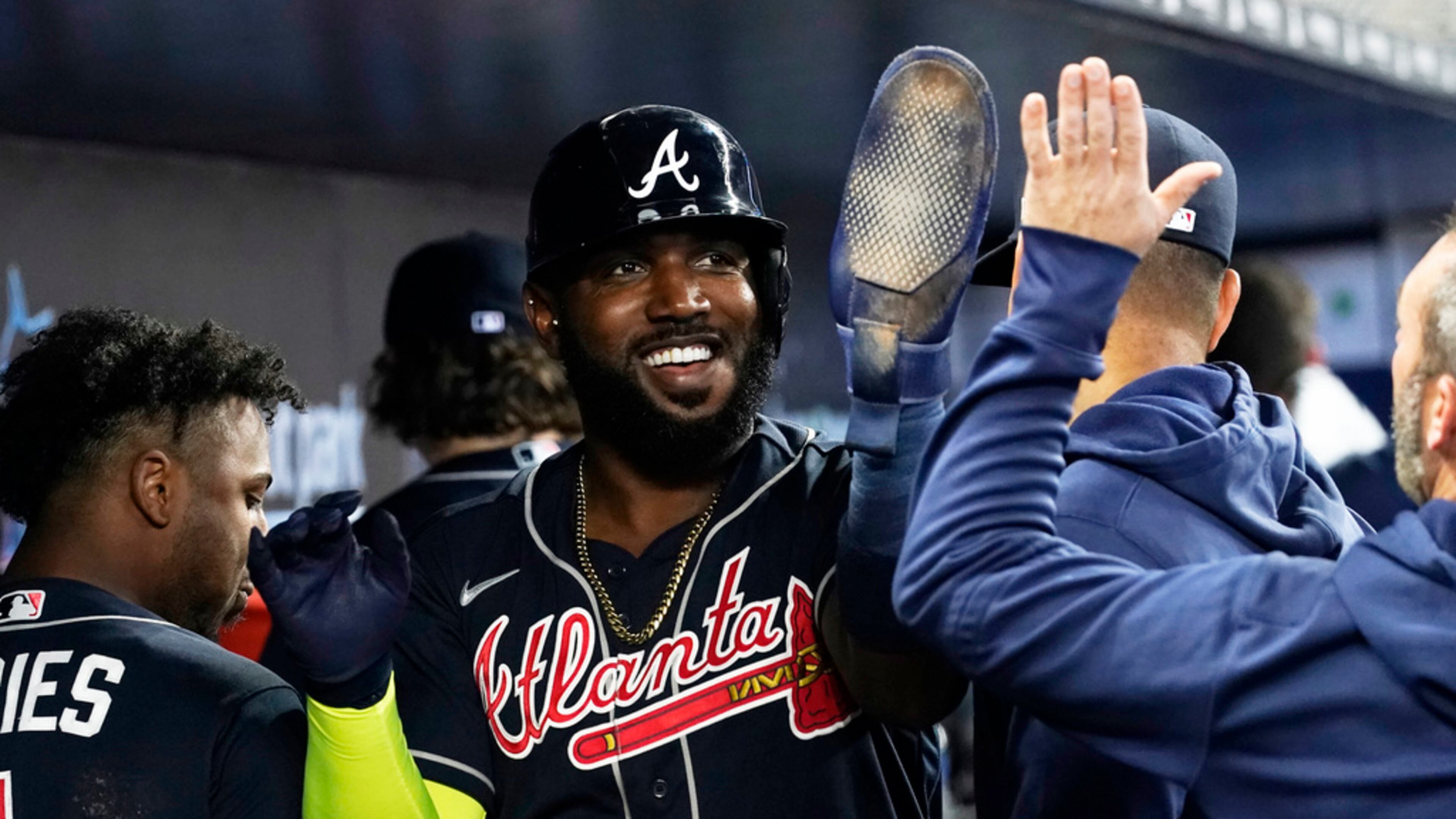 Atlanta Braves Marcell Ozuna (20) is congratulates by his teammates after scoring in the second inning of a baseball game against the Miami Marlins, Thursday, May 4, 2023, in Miami. (AP Photo/Marta Lavandier)