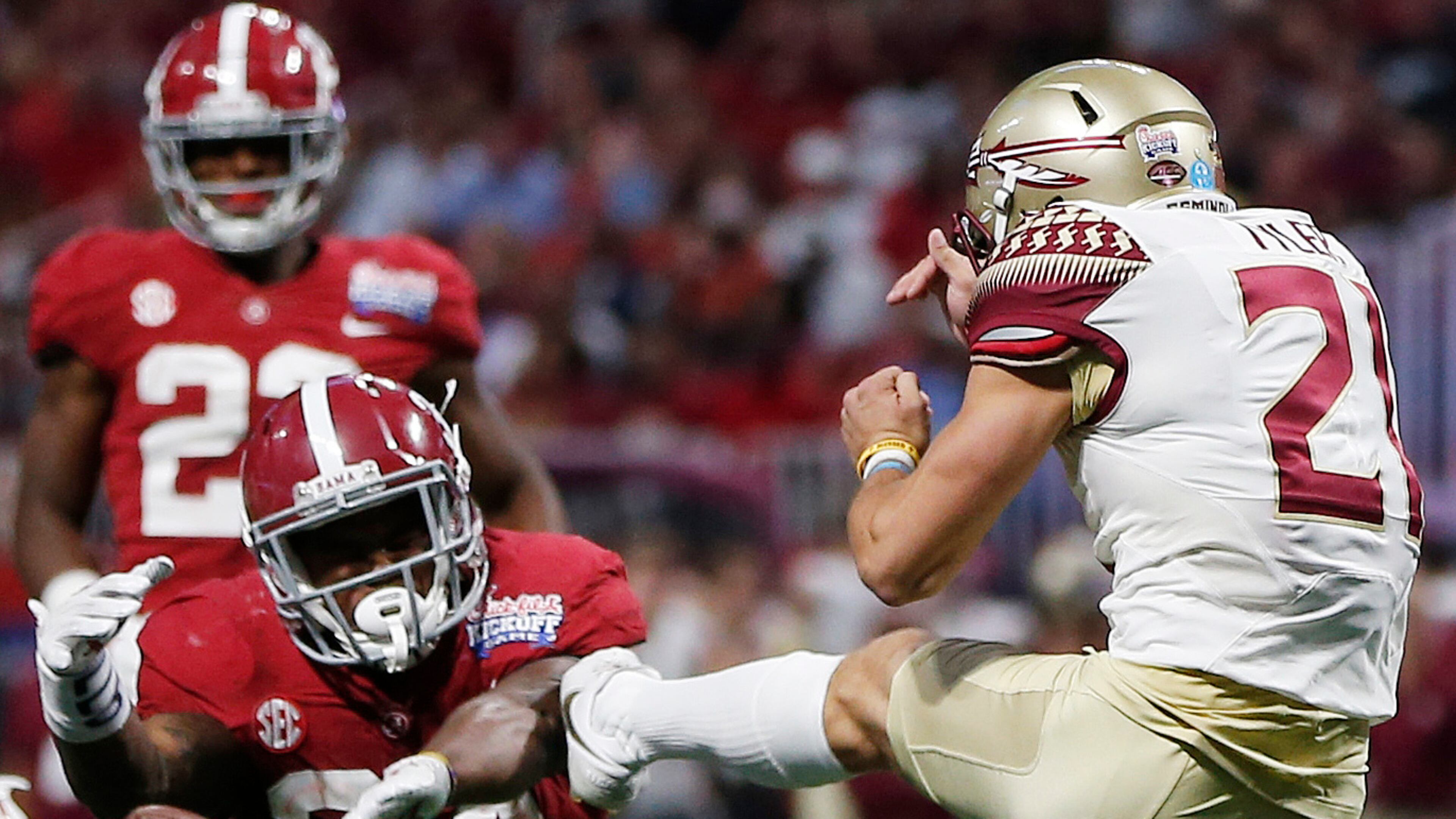 Alabama running back Damien Harris (34) blocks a punt by Florida State place kicker Logan Tyler (21) during the second half of an NCAA football game, Saturday, Sept. 2, 2017, in Atlanta. Alabama's Josh Jacobs recovered the ball. (AP Photo/John Bazemore)