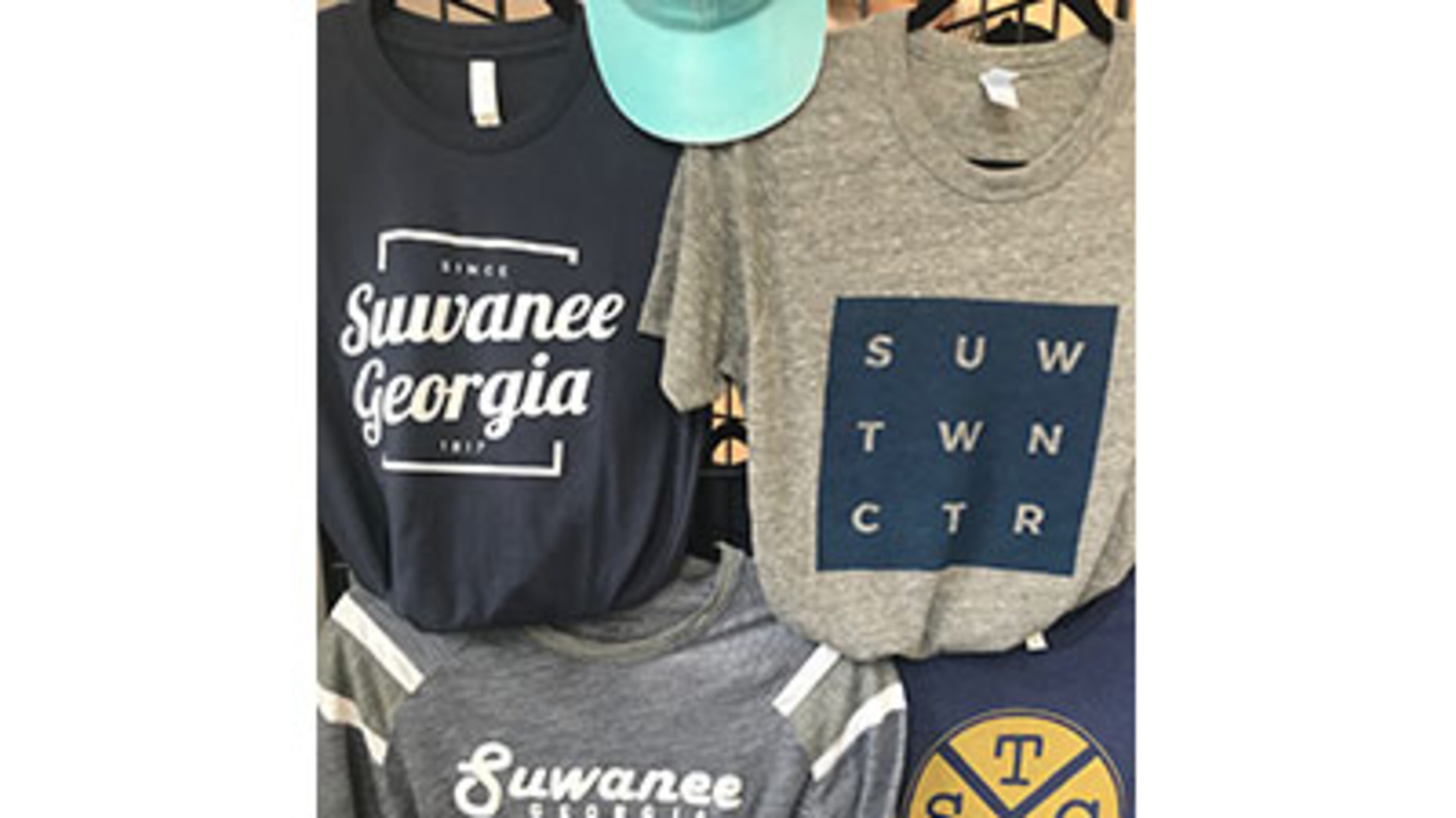 Merchandise like these t-shirts is sold in the Suwanee Welcome Center operated by the North Gwinnett Arts Association in conjunction with the city. Suwanee and the NGAA recently updated how proceeds from sales will be shared. Courtesy City of Suwanee