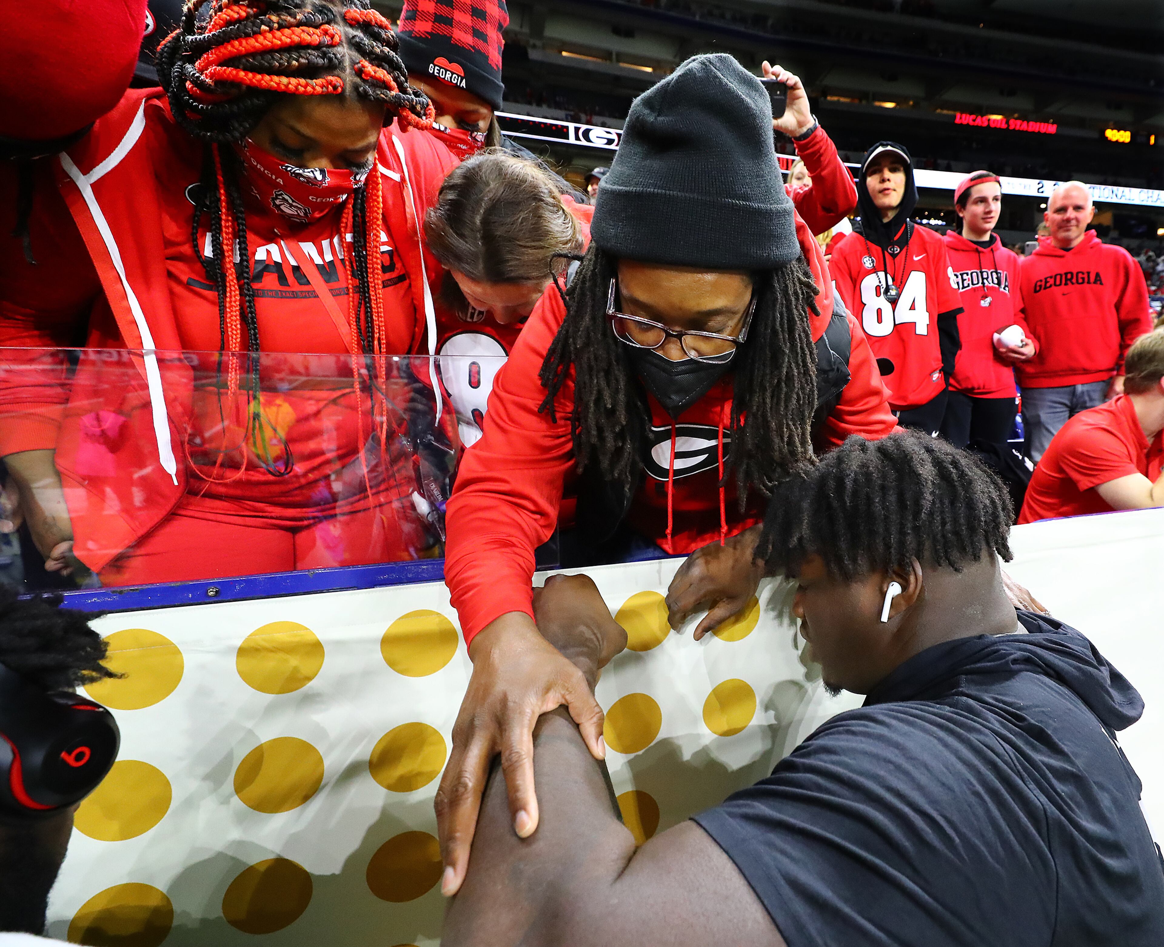 Georgia defensive tackle Jordan Davis prays with his mother Shay Allen before playing Alabama in the College Football Playoff Championship game on Monday, Jan. 10, 2022, in Indianapolis. Davis finds his mother in the stands before every Georgia game embracing, praying, and cherishing the rare moments they spend together in person. “Curtis Compton / Curtis.Compton@ajc.com”`