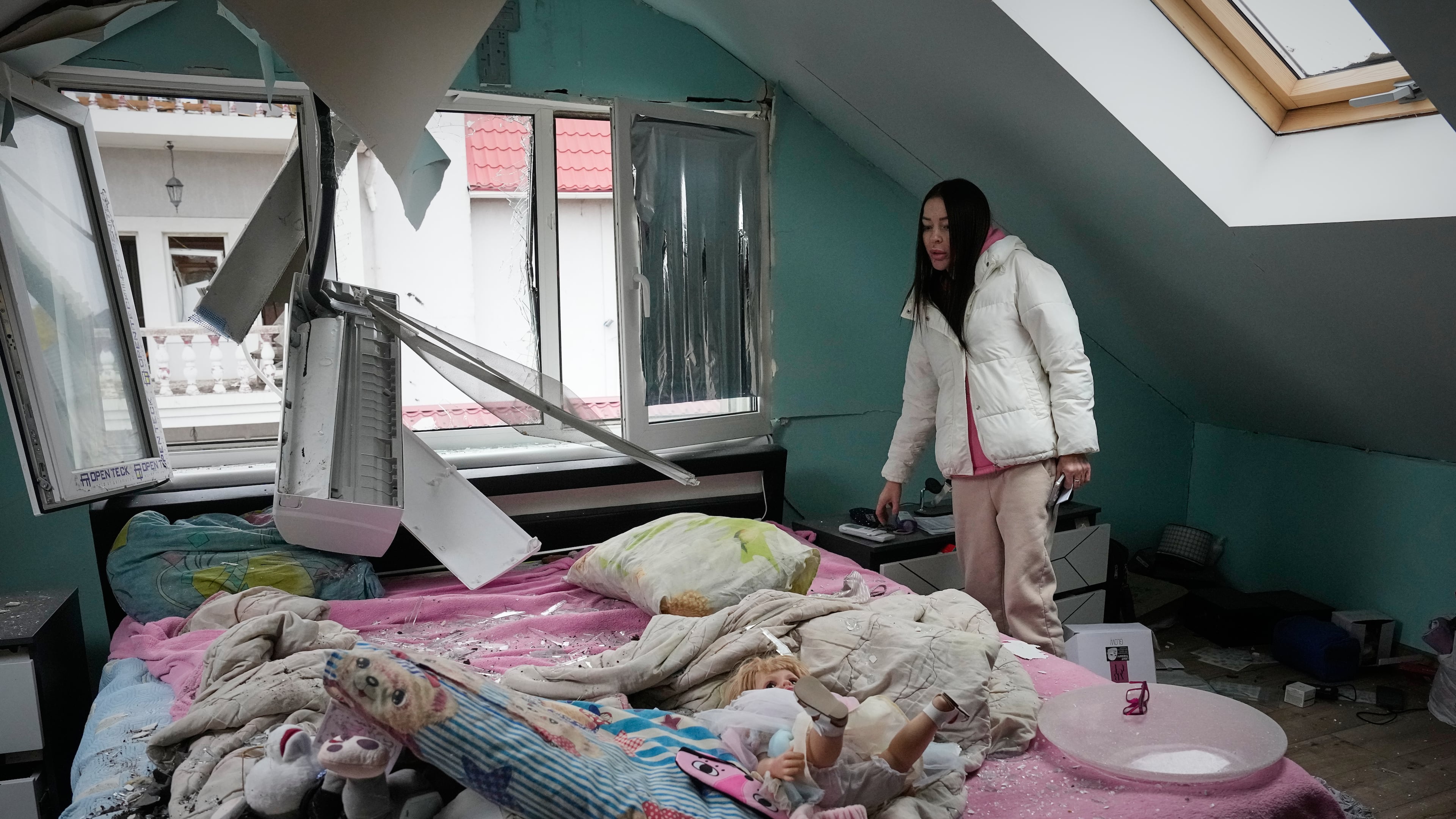 A woman looks at her damaged apartment after a Russian missile attack in Kyiv, Ukraine, Thursday, Oct. 22, 2026. (AP Photo/Efrem Lukatsky)