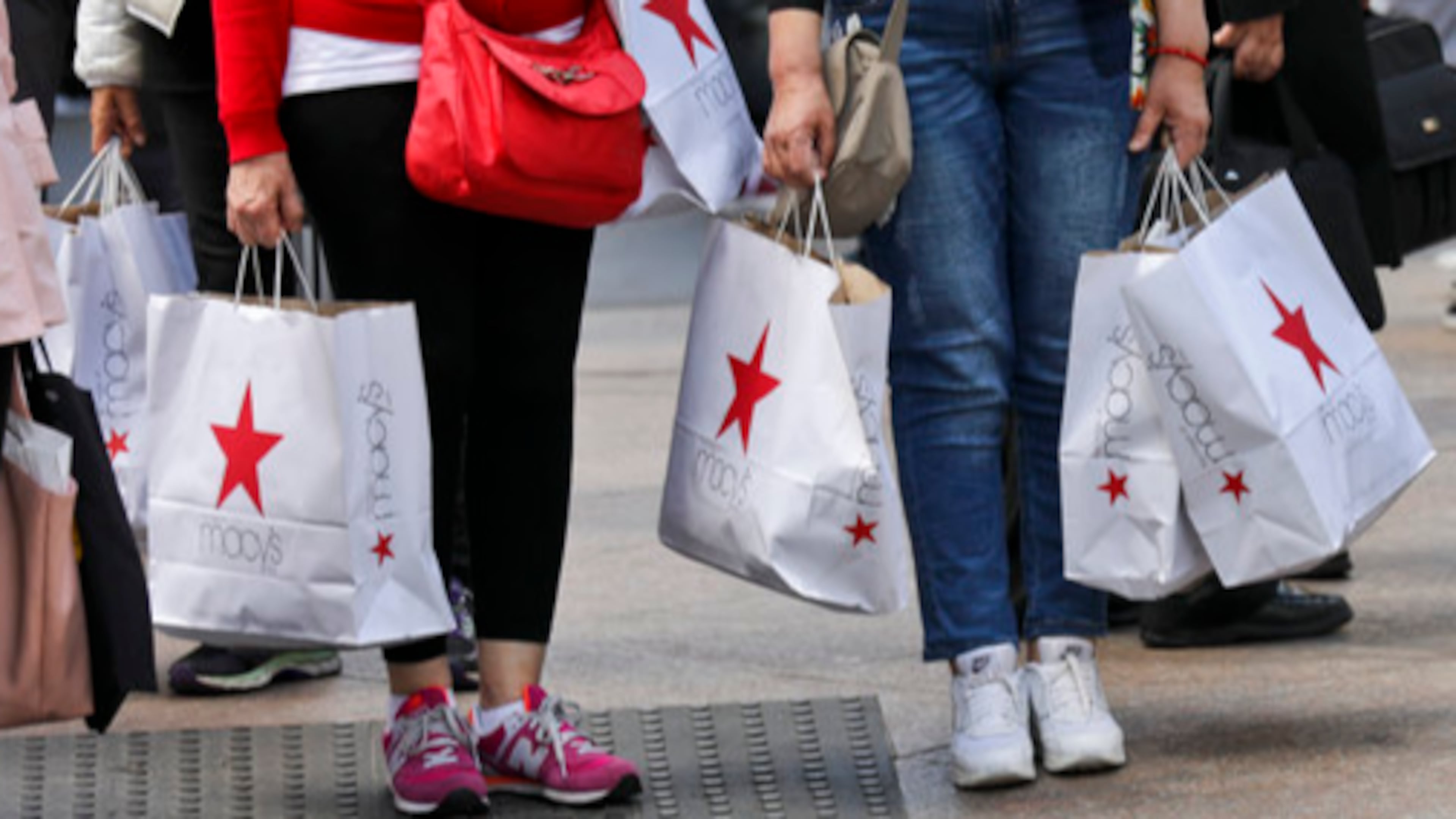 In this Tuesday, May 2, 2017, photo, shoppers holding bags from Macy's wait to cross an intersection in New York. Macy's Inc. reports earnings, Thursday, May 11, 2017. (AP Photo/Bebeto Matthews)
