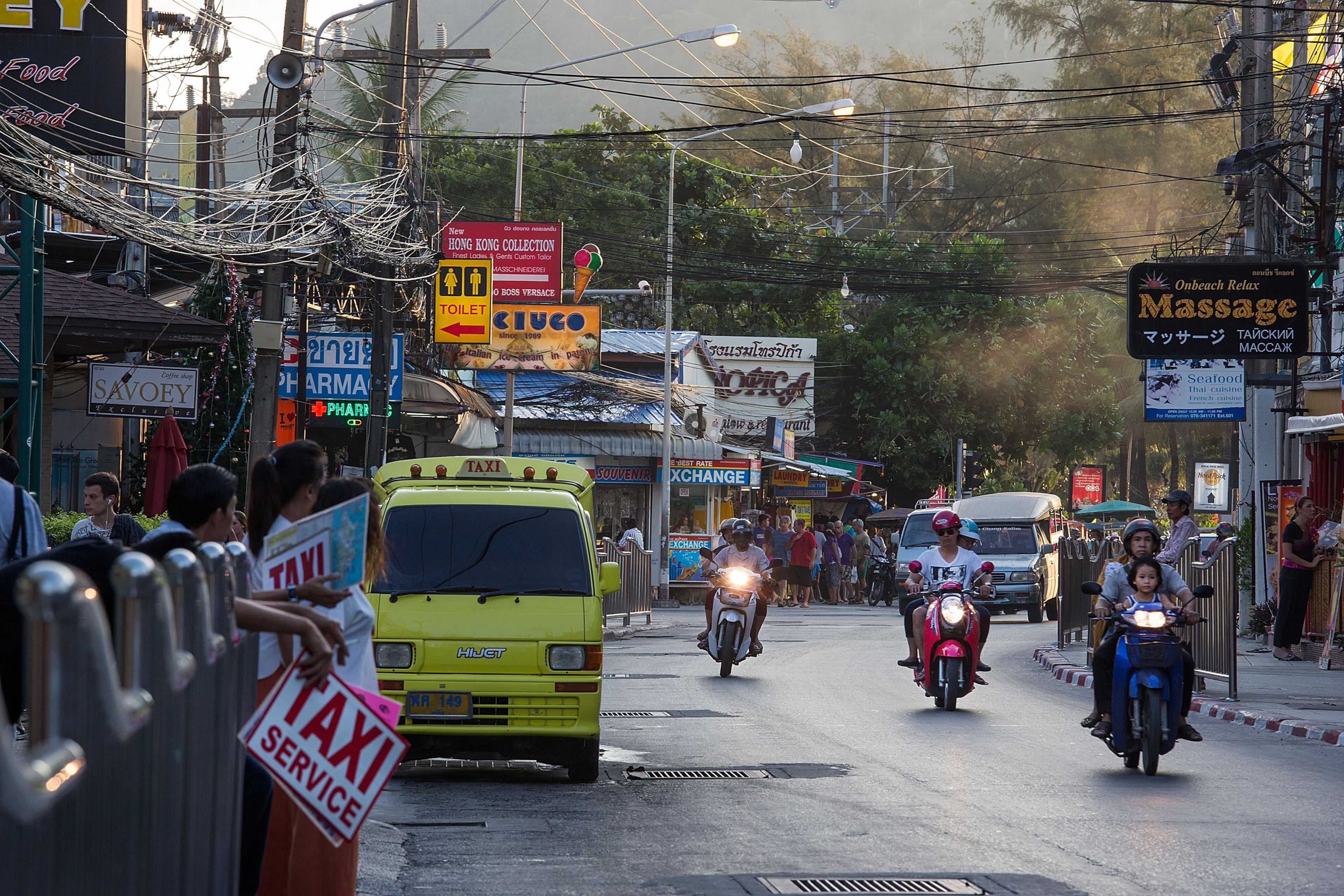 PHUKET, THAILAND - DECEMBER 10: Motorbikes, vans, cars, and taxis travel along a busy Patong road running parallel to the beach on December 10, 2014 at Patong Beach in Phuket, Thailand. The tenth anniversary of the 2004 Indian Ocean earthquake and tsunami killing almost 250,000 people will be remembered on December 26. (Photo by Taylor Weidman/Getty Images)
