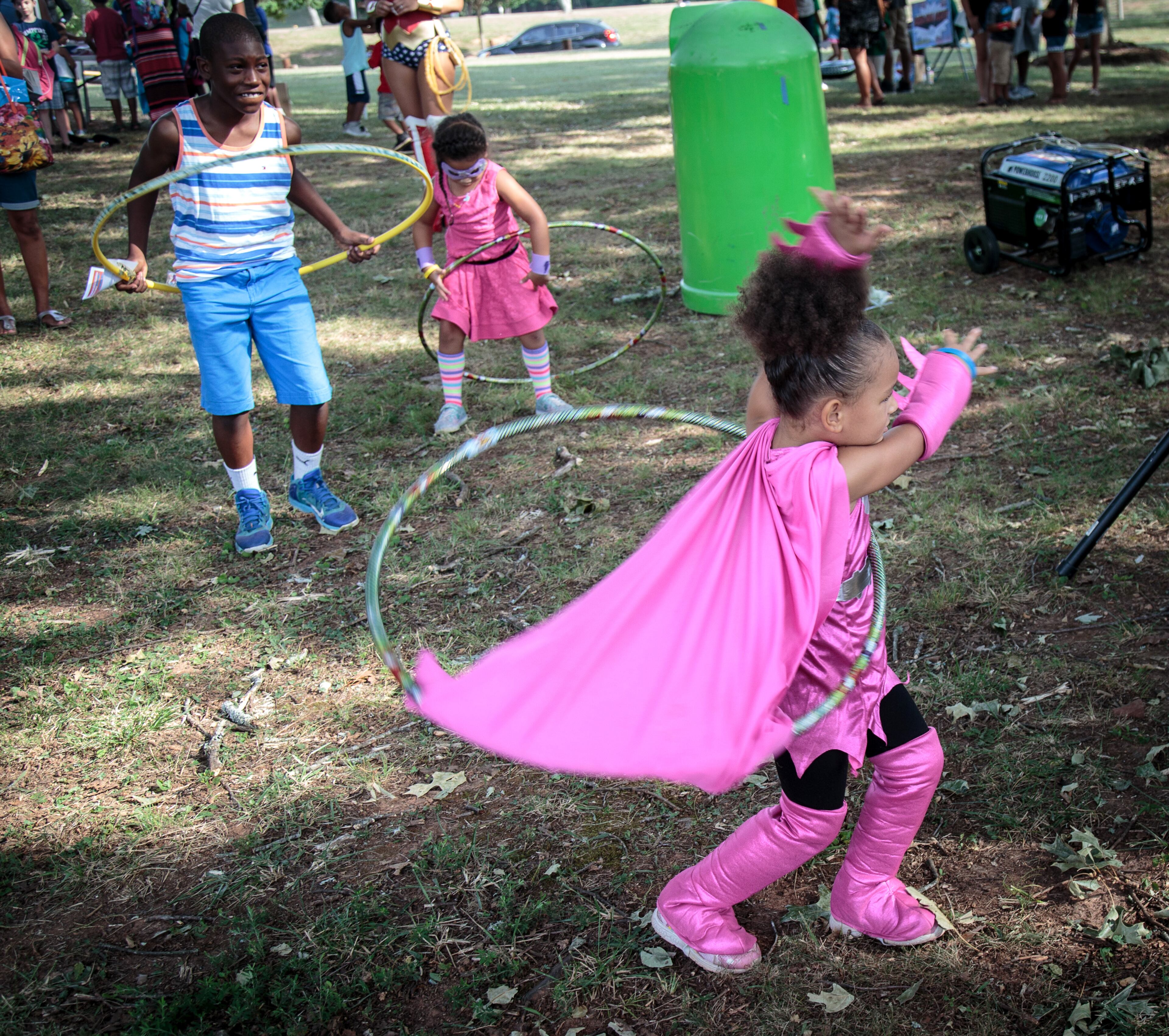 Paradise Muhammed gets her Hula Hoop tangled up in her batgirl cape during Superhero Saturday at Lenora Park in Snellville, Ga. Saturday, July 16, 2016 STEVE SCHAEFER / SPECIAL TO THE AJC