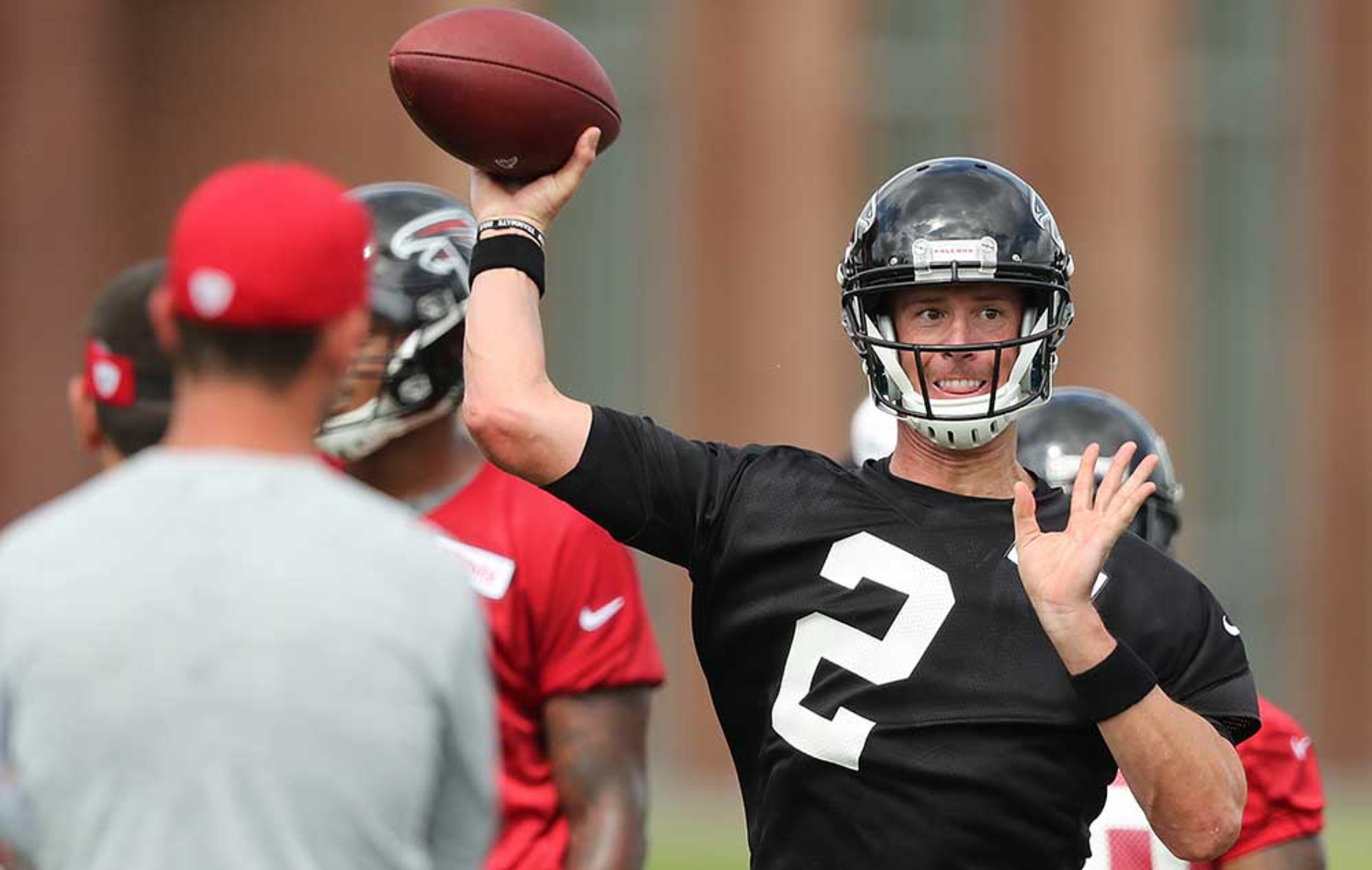 Matt Ryan throws a pass while offensive coordinator Kyle Shanahan watches.
