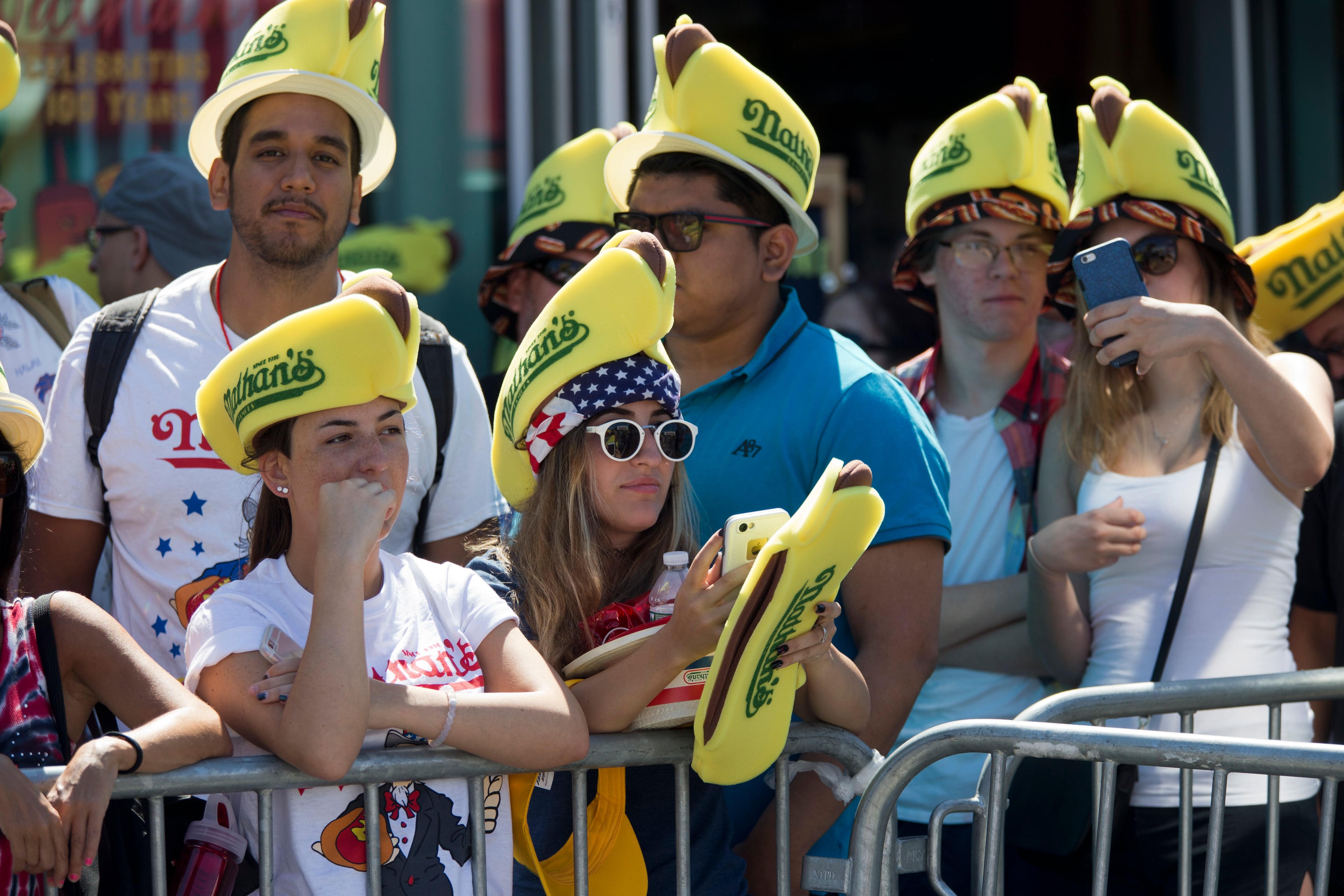 Spectators wait for the Nathan's Famous Fourth of July International Hot Dog Eating Contest to begin, Monday, July 4, 2016, in New York. (AP Photo/Mary Altaffer)