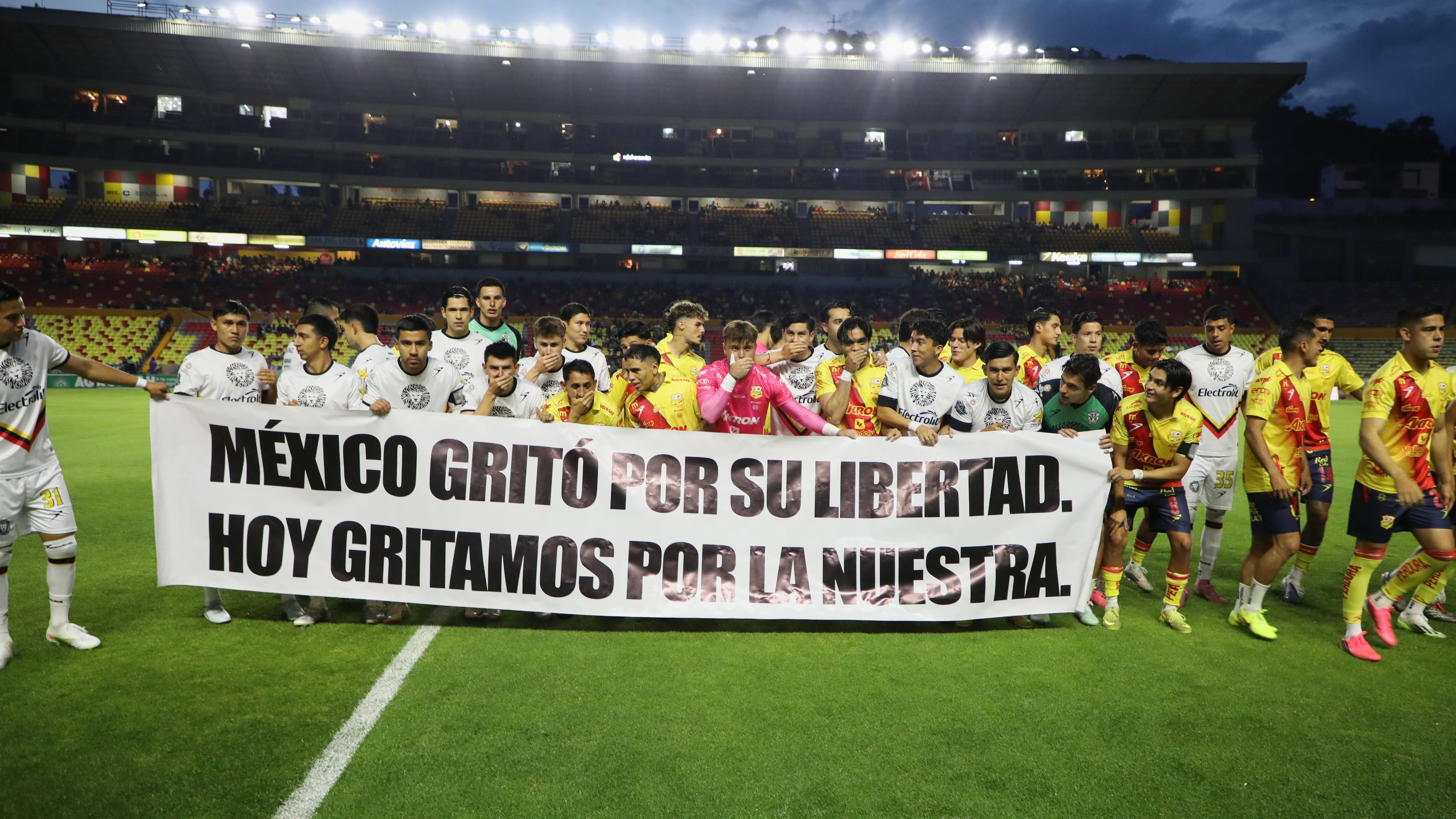 Players of Atletico Morelia and Leones Negros hold a sign that reads, "Mexico shouted for its freedom. Today, we shout for ours," before a Mexican second-division soccer match in Morelia, Michoacan state, Mexico, Saturday, Sept. 19, 2026. (AP Photo/Armando Solis)