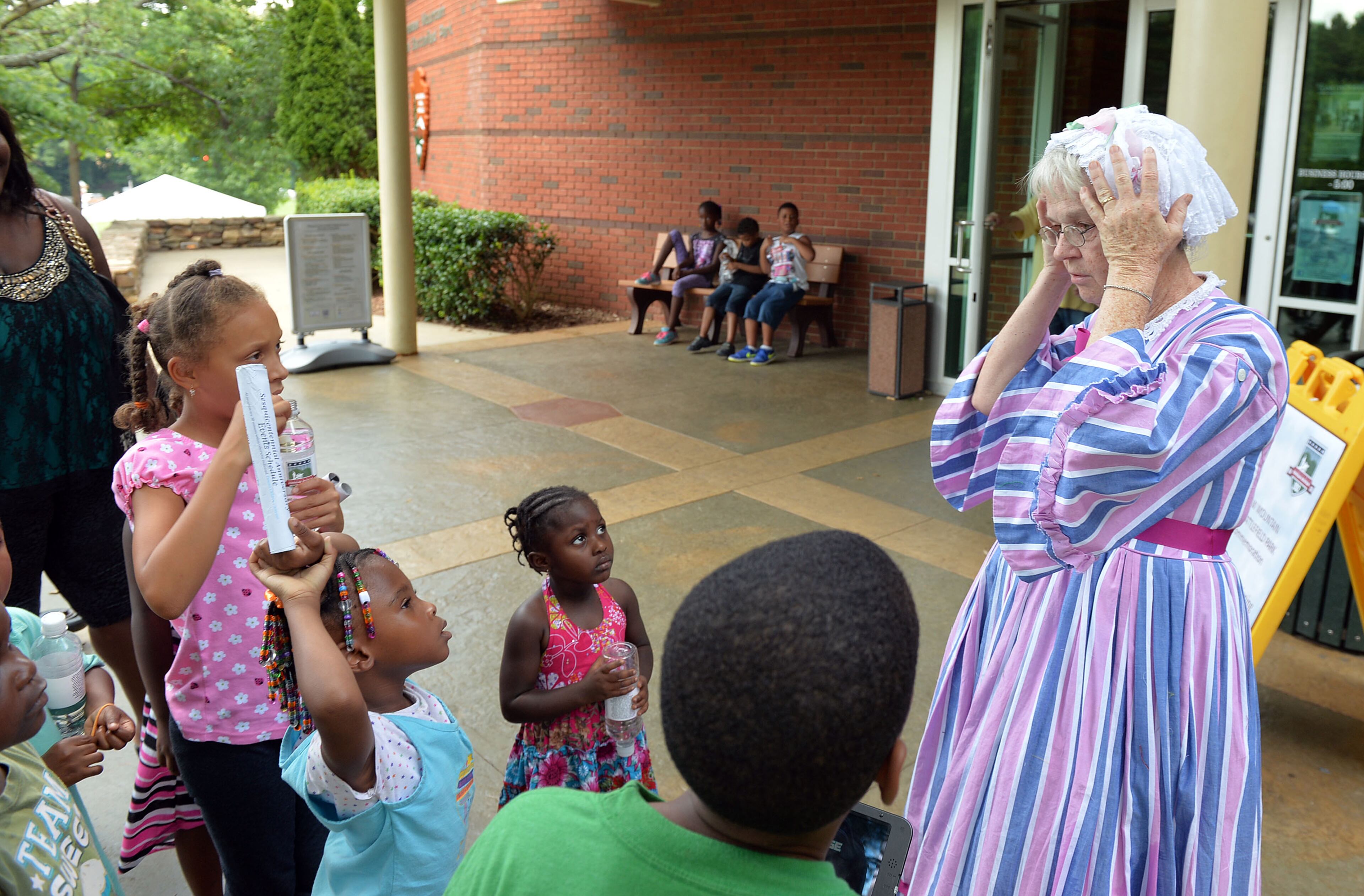 Southerner Lucy Sommer of Acworth, talks with students in a summer camp program at Kennesaw Mountain National Battlefield Park Friday, June 27, 2014.