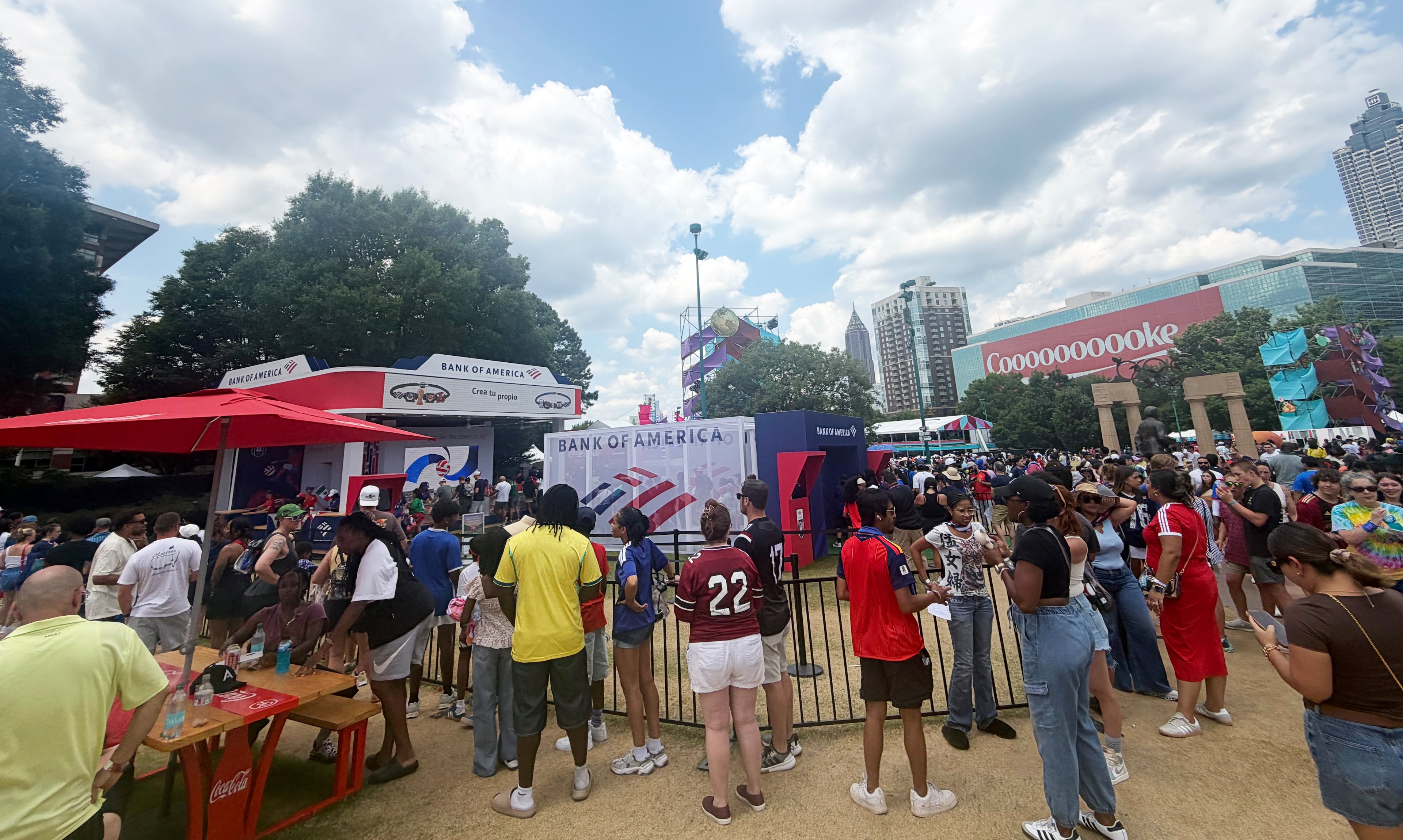 Fans wait outside a booth at Centennial Olympic Park to make a custom bracelet to commemorate the World Cup. (Andre Butso/AJC)