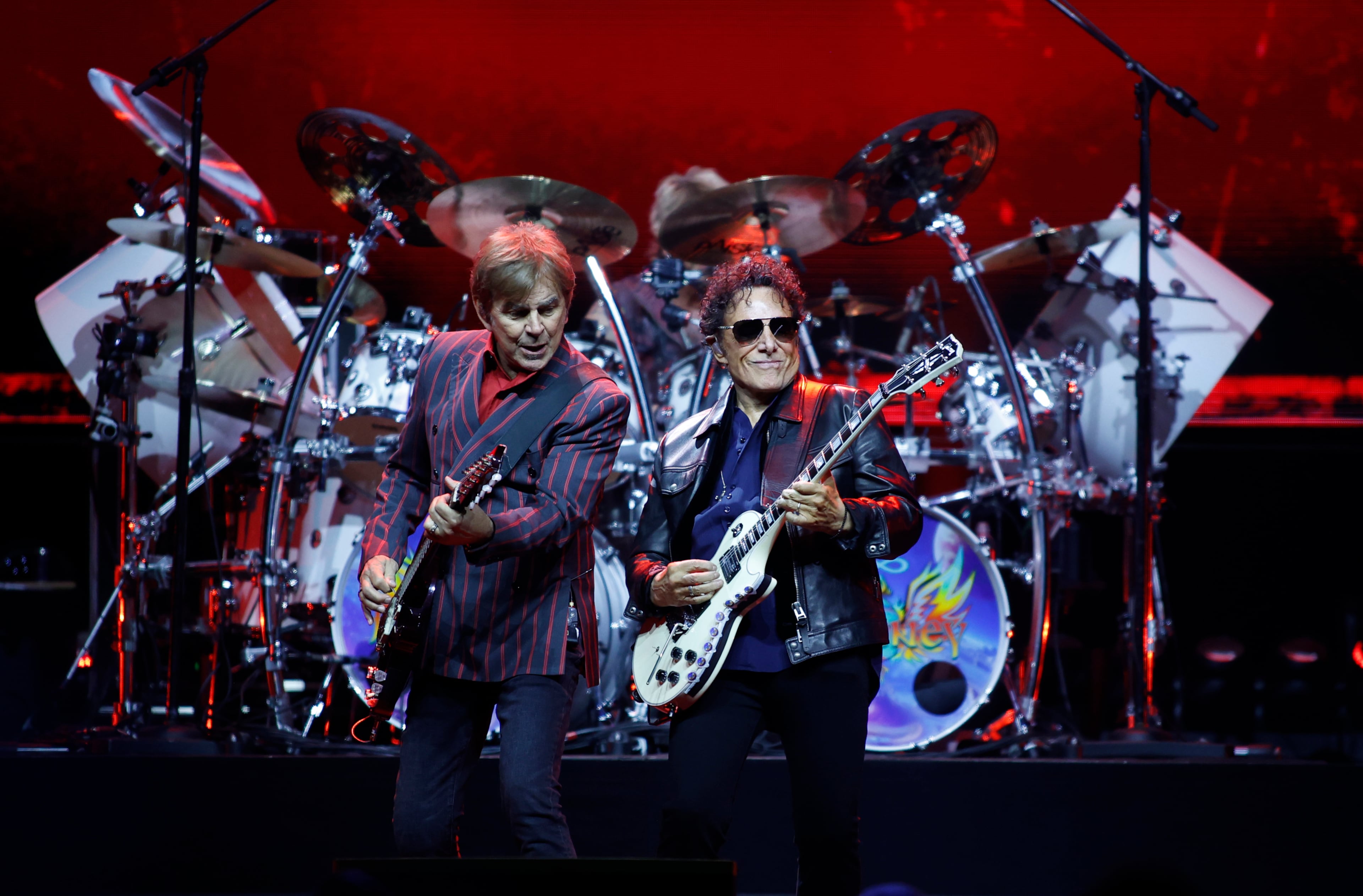 Journey rhythm guitarist Jonathan Cain (left) and lead guitarist Neal Schon duel it out at the Atlanta State Farm Arena. (Akili-Casundria Ramsess for the AJC)