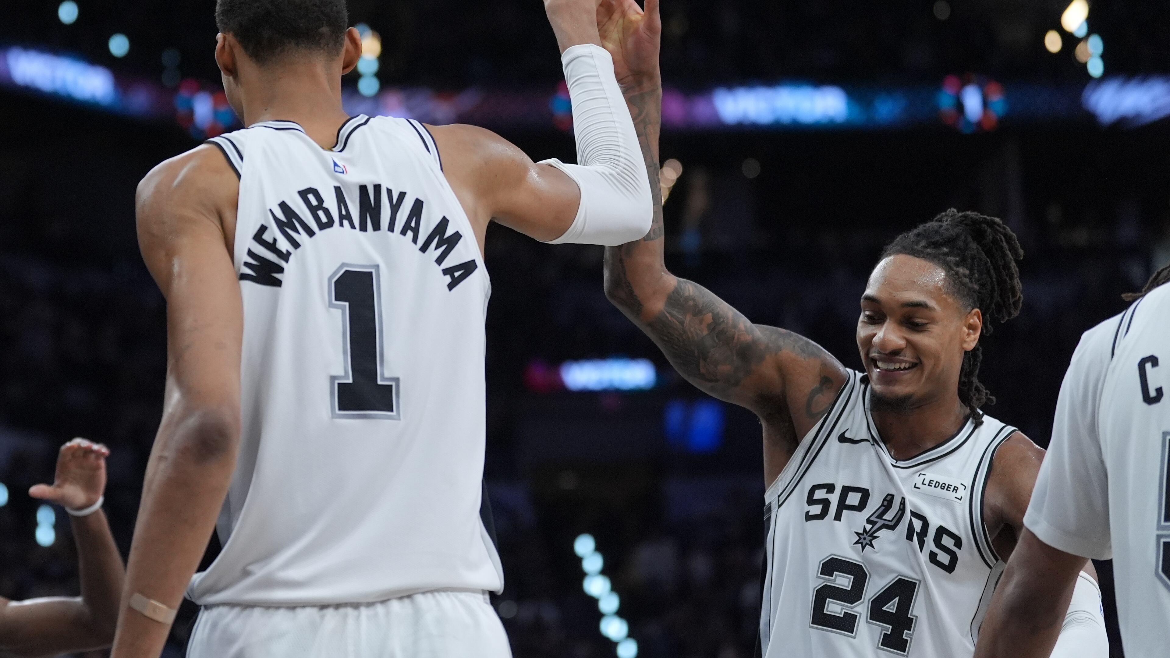 San Antonio Spurs forward/center Victor Wembanyama (1) reacts with guard/forward Devin Vassell (24) during the second half in Game 5 of a first-round NBA playoffs basketball series against the Portland Trail Blazers, in San Antonio, Tuesday, April 28, 2026. (AP Photo/Eric Gay)