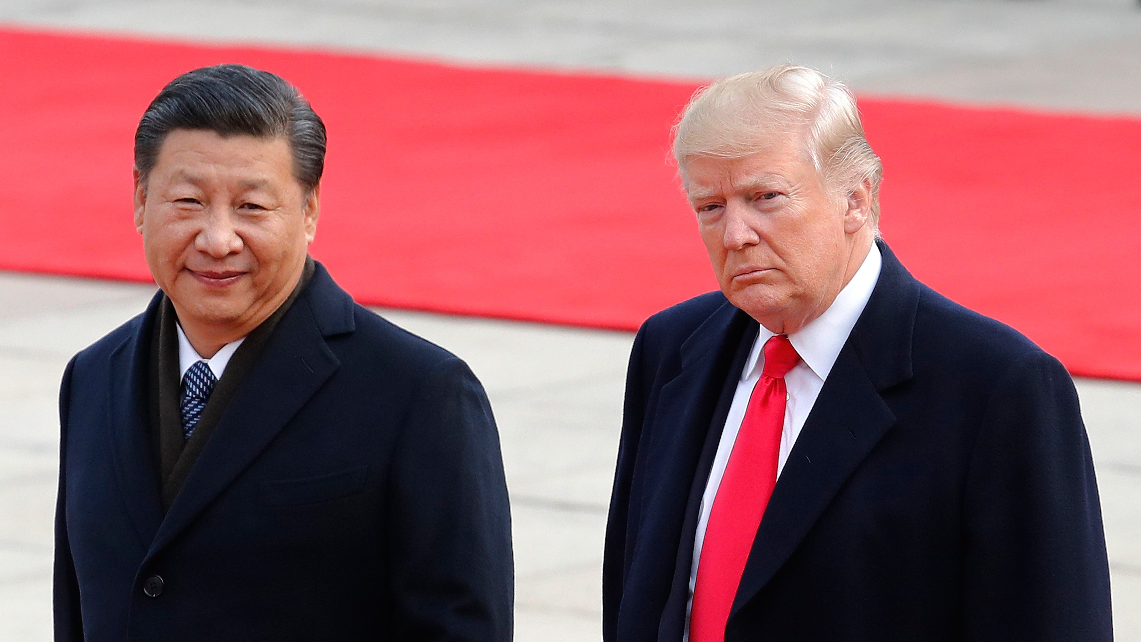 FILE - President Donald Trump, right, walks with Chinese President Xi Jinping during a welcome ceremony at the Great Hall of the people in Beijing, Nov. 9, 2017. (AP Photo/Andy Wong, File)