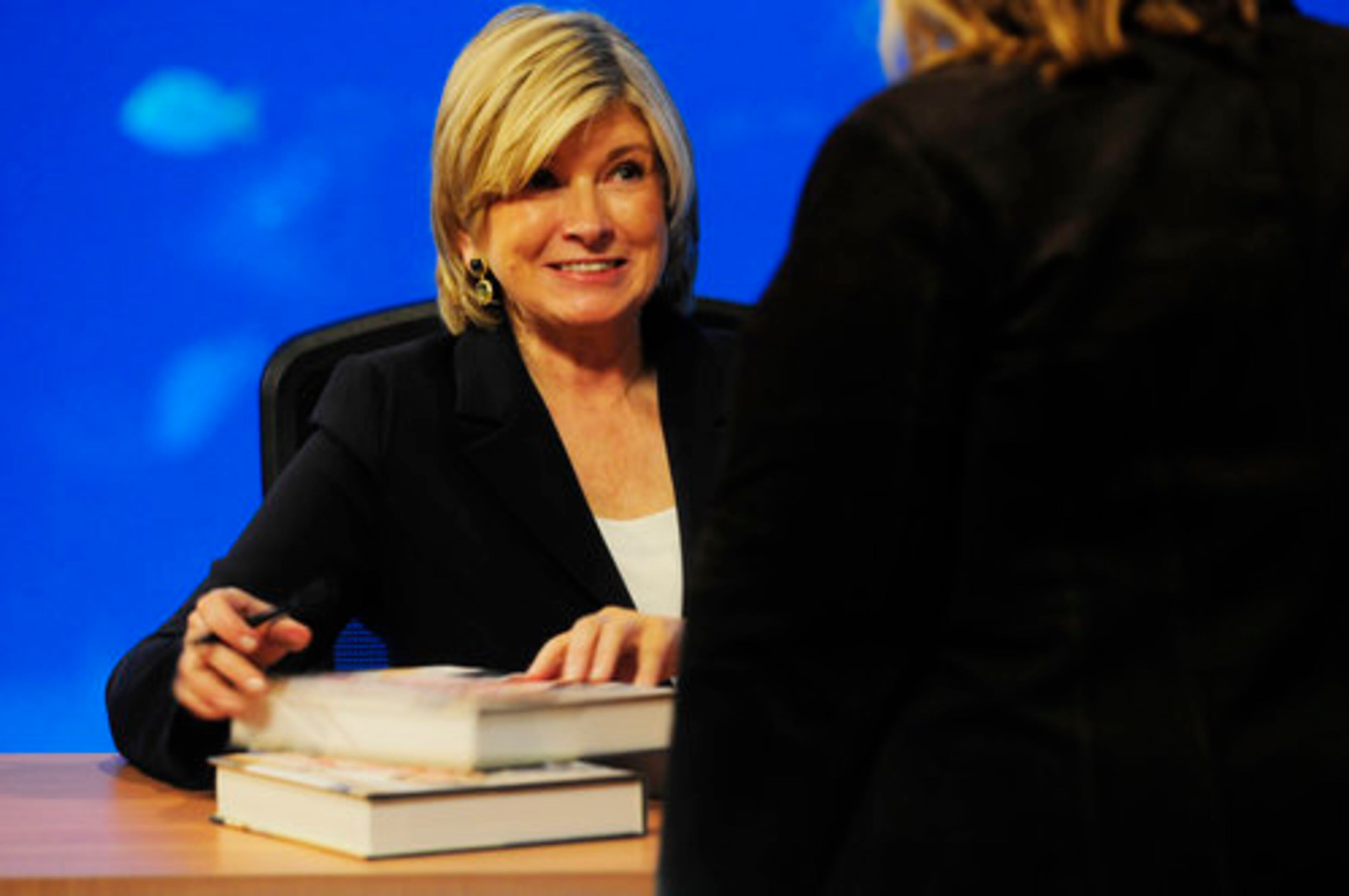 Martha Stewart signs two of her cookbooks at the Georgia Aquarium in Atlanta on Feb. 17, 2009.
