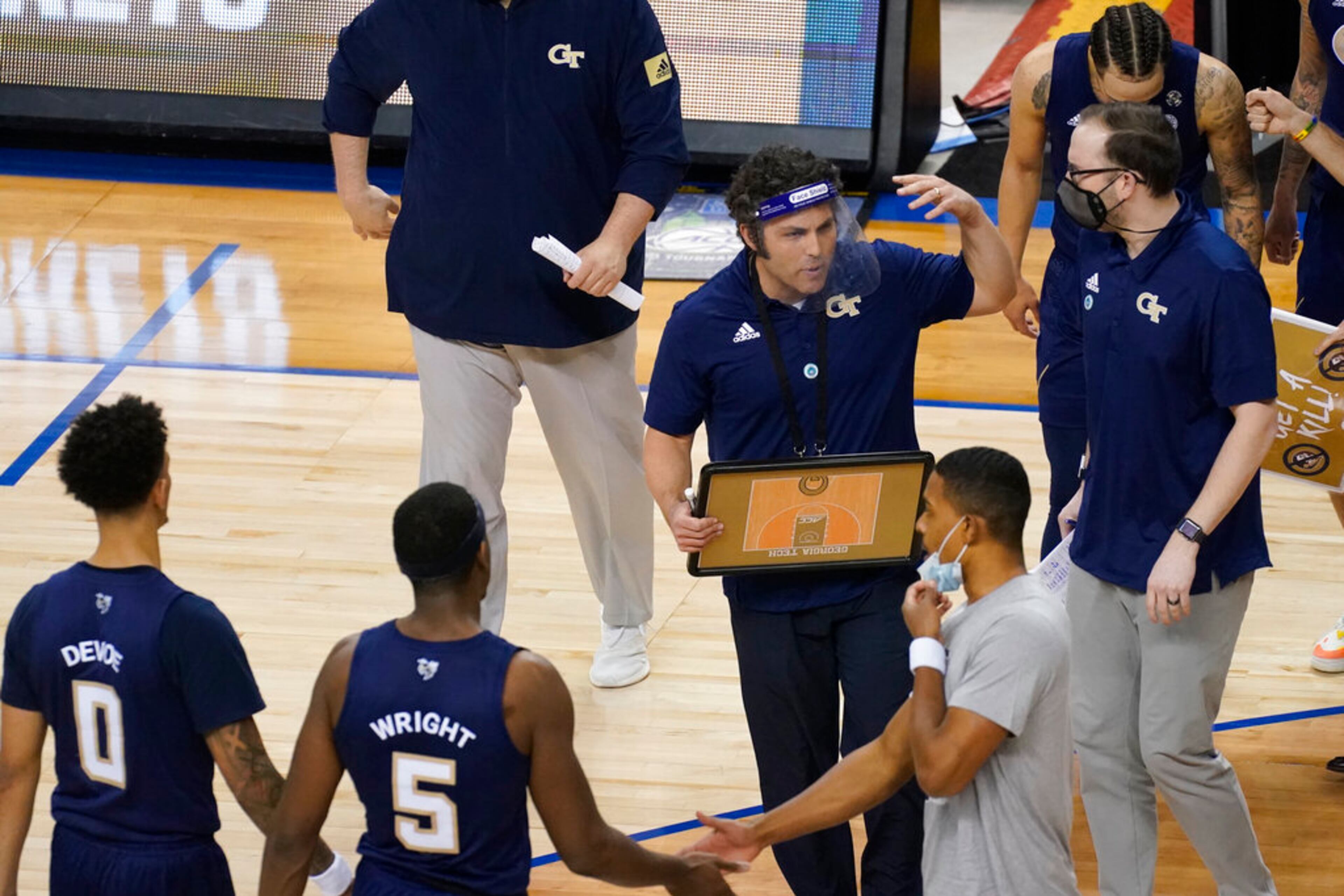 Georgia Tech head coach Josh Pastner, center, gathers his team during the second half of an NCAA college basketball Championship game against Florida State at the Atlantic Coast Conference tournament in Greensboro, N.C., Saturday, March 13, 2021. (AP Photo/Gerry Broome)