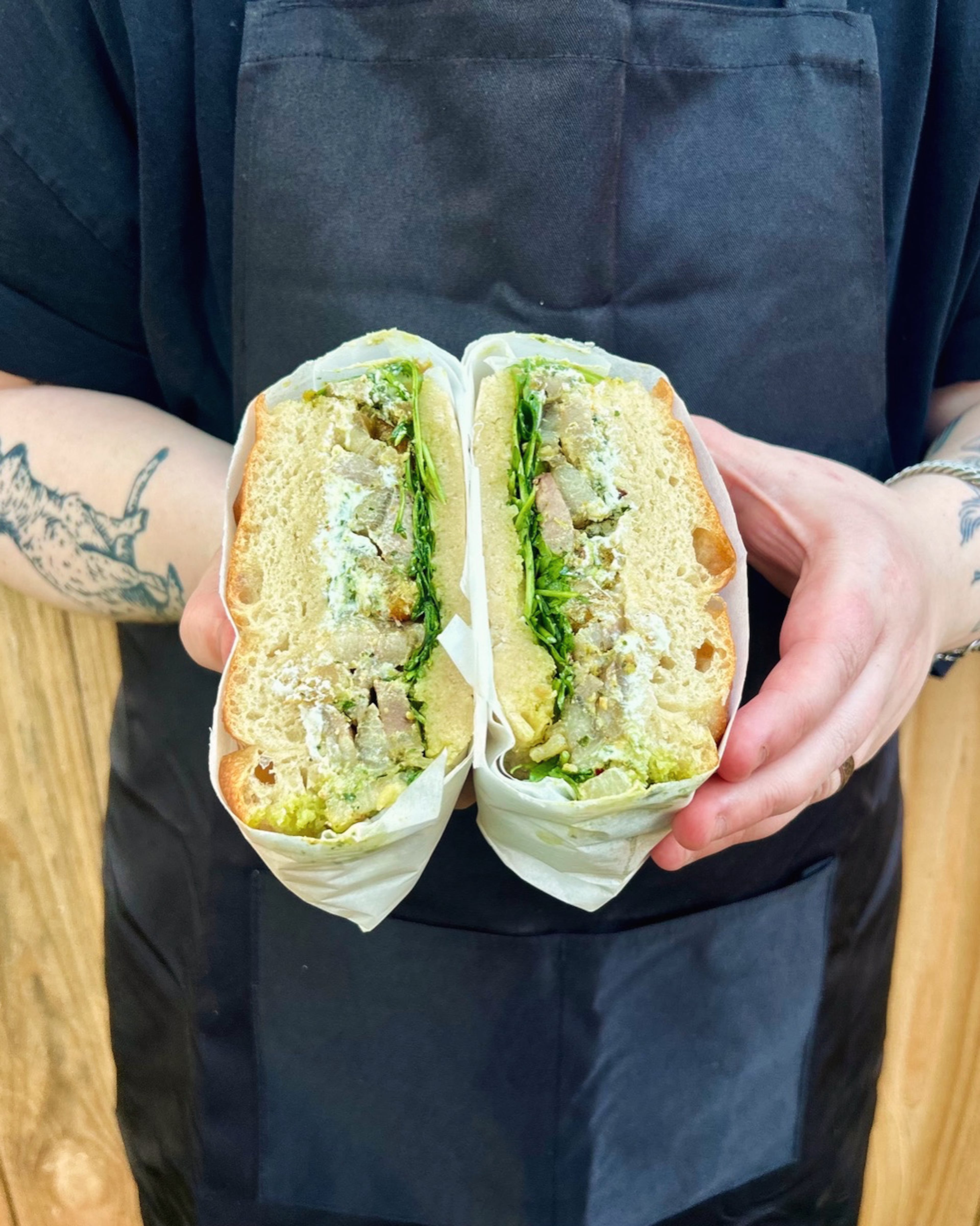 Fool’s Errand’s porchetta sandwich with homemade focaccia, salsa verde, whipped ricotta and arugula. (Courtesy of Hannah Chandler)