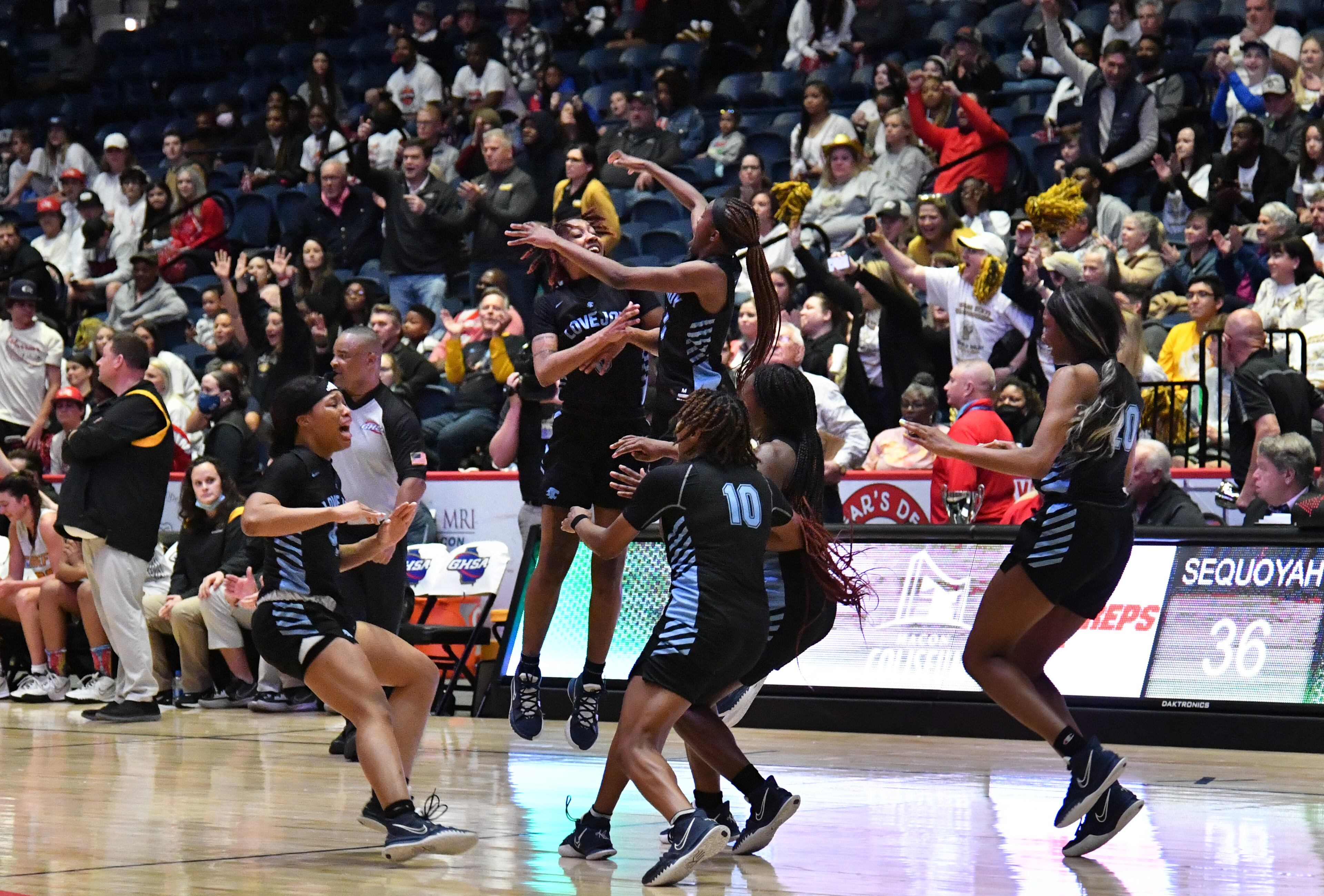 March 11, 2022 Macon - Lovejoy players celebrate their victory over Sequoyah during the 2022 GHSA State Basketball Class AAAAAA Girls Championship game at the Macon Centreplex in Macon on Friday, March 11, 2022. Lovejoy won 54-38 over Sequoyah. (Hyosub Shin / Hyosub.Shin@ajc.com)