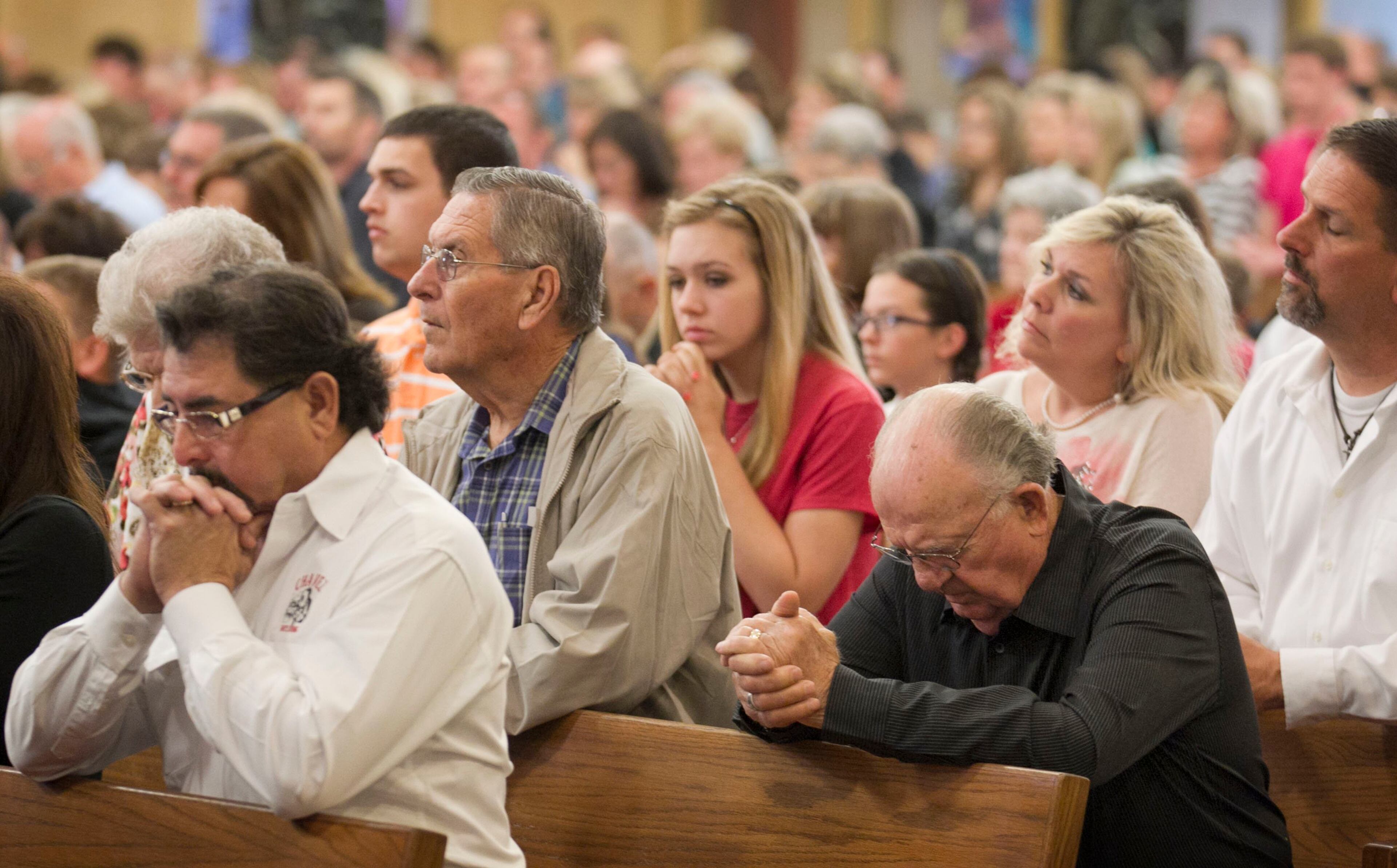 People pray during worship service at Assumption Catholic Church in West on Sunday April 21, 2013, days after a fertilizer plant explosion killed 14 people.