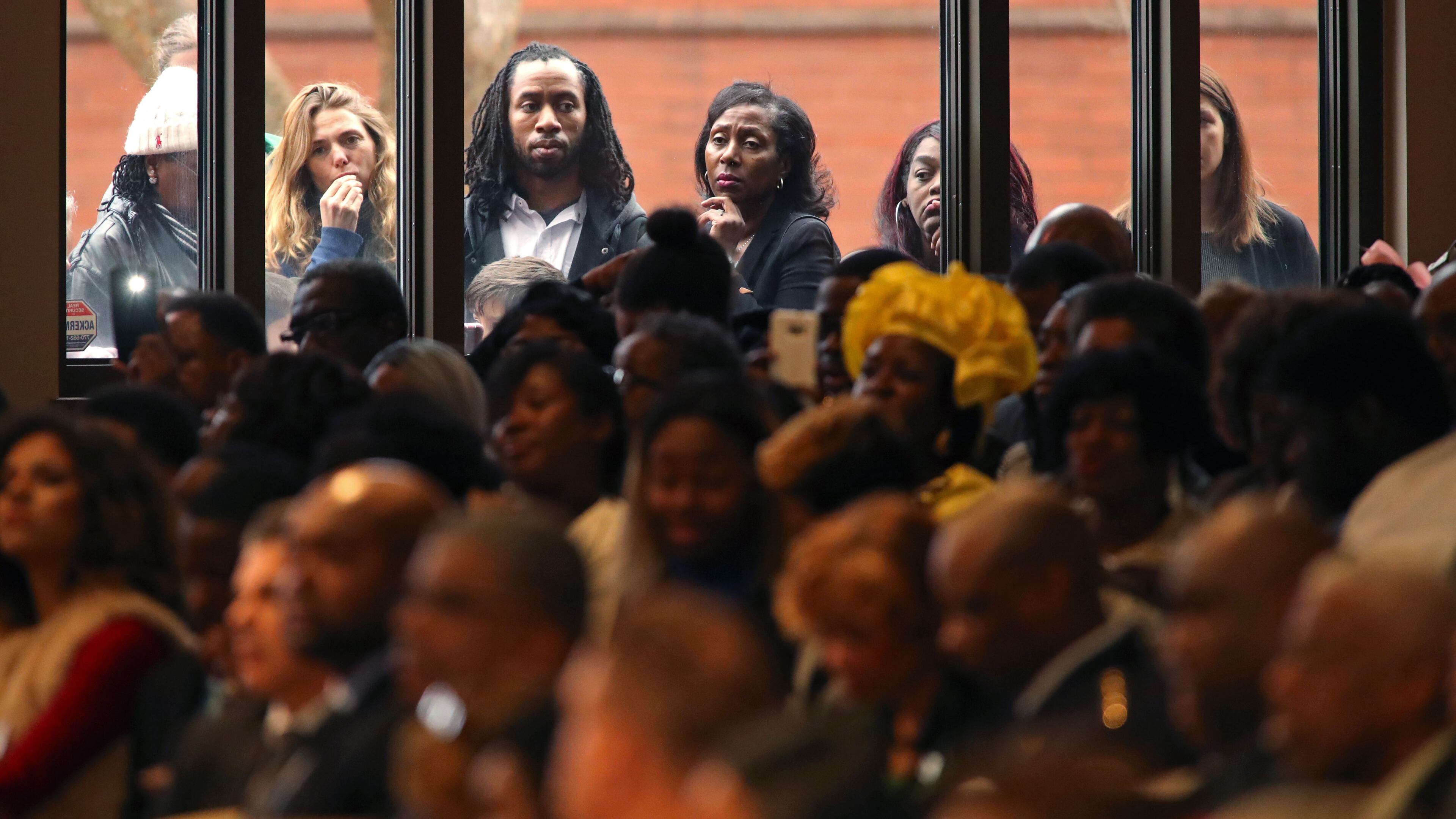 January 16, 2017 - Atlanta, Ga: People watch through a window from outside during the 49th annual Martin Luther King Jr. Commemorative Service at Ebenezer Baptist Church Monday, January 16, 2017, in Atlanta, Ga. PHOTO / JASON GETZ