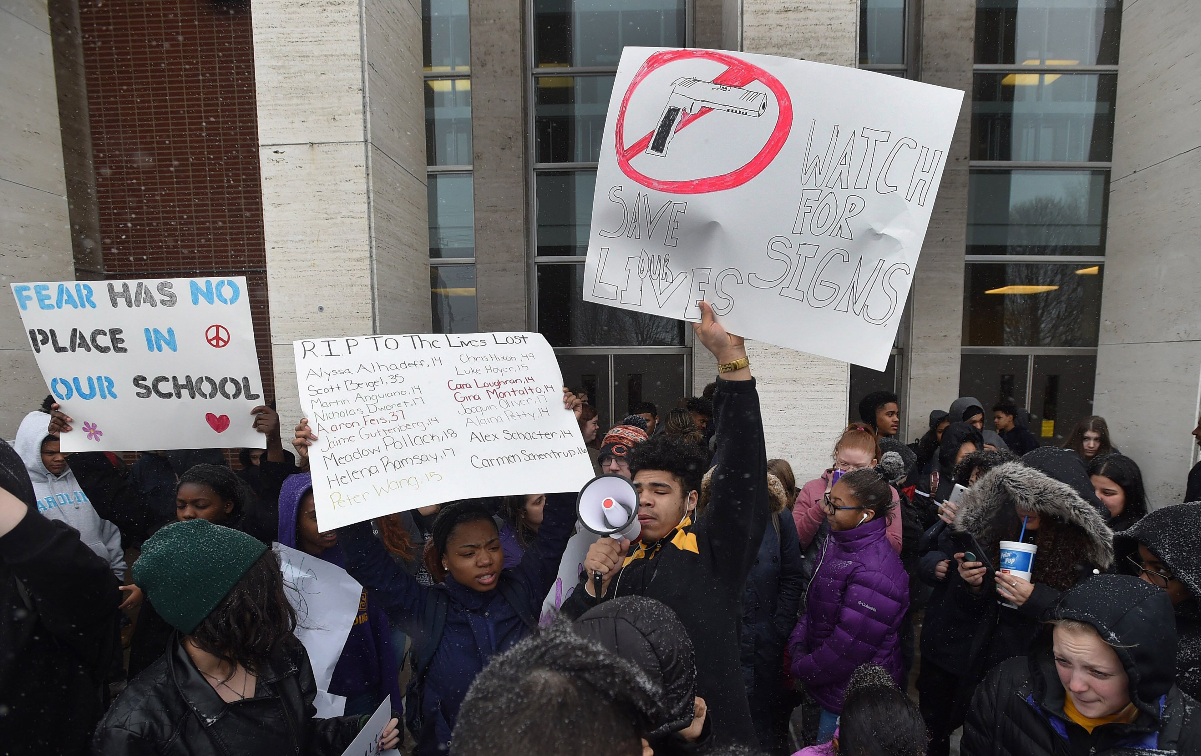 Gabe Martin, 17, center, a senior at Erie High School, speaks to fellow students during a student walkout on Wednesday, March 14, 2018 to protest gun violence in schools in Eire, Pa. Students across the country planned to participate in walkouts Wednesday to protest gun violence, one month after the deadly shooting inside a high school in Parkland, Fla. (Jack Hanrahan/Erie Times-News via AP)