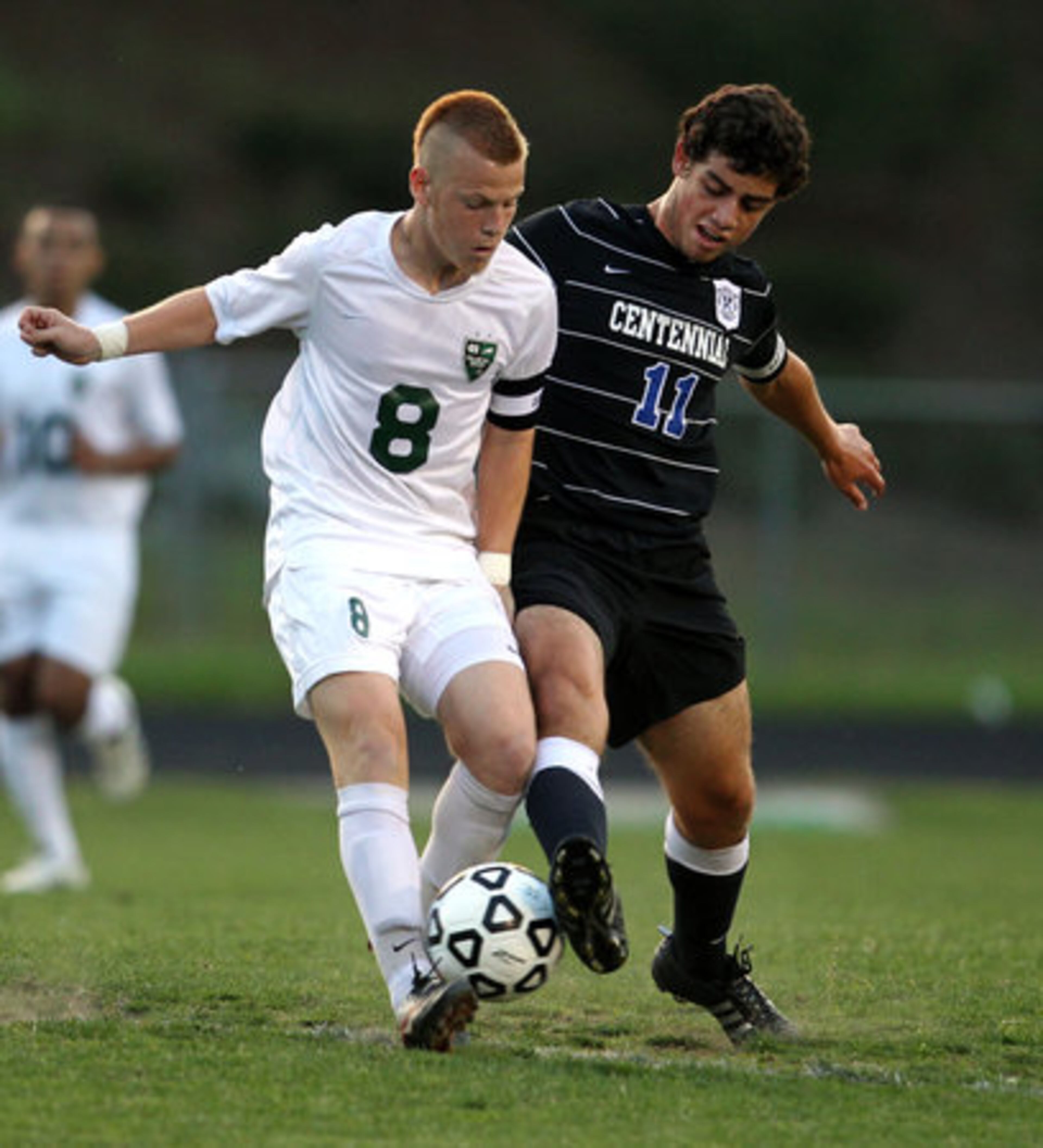 Collins Hill's Nomis Cisic (8) fights for possession of the ball against Centennial's Amin El-Shami (11) in the first half of their Class AAAAA boys soccer state championship game at Collins Hill High School Friday night in Suwanee, Ga., May 18, 2012. Cisic scored Collins Hill's first goal of the game.
