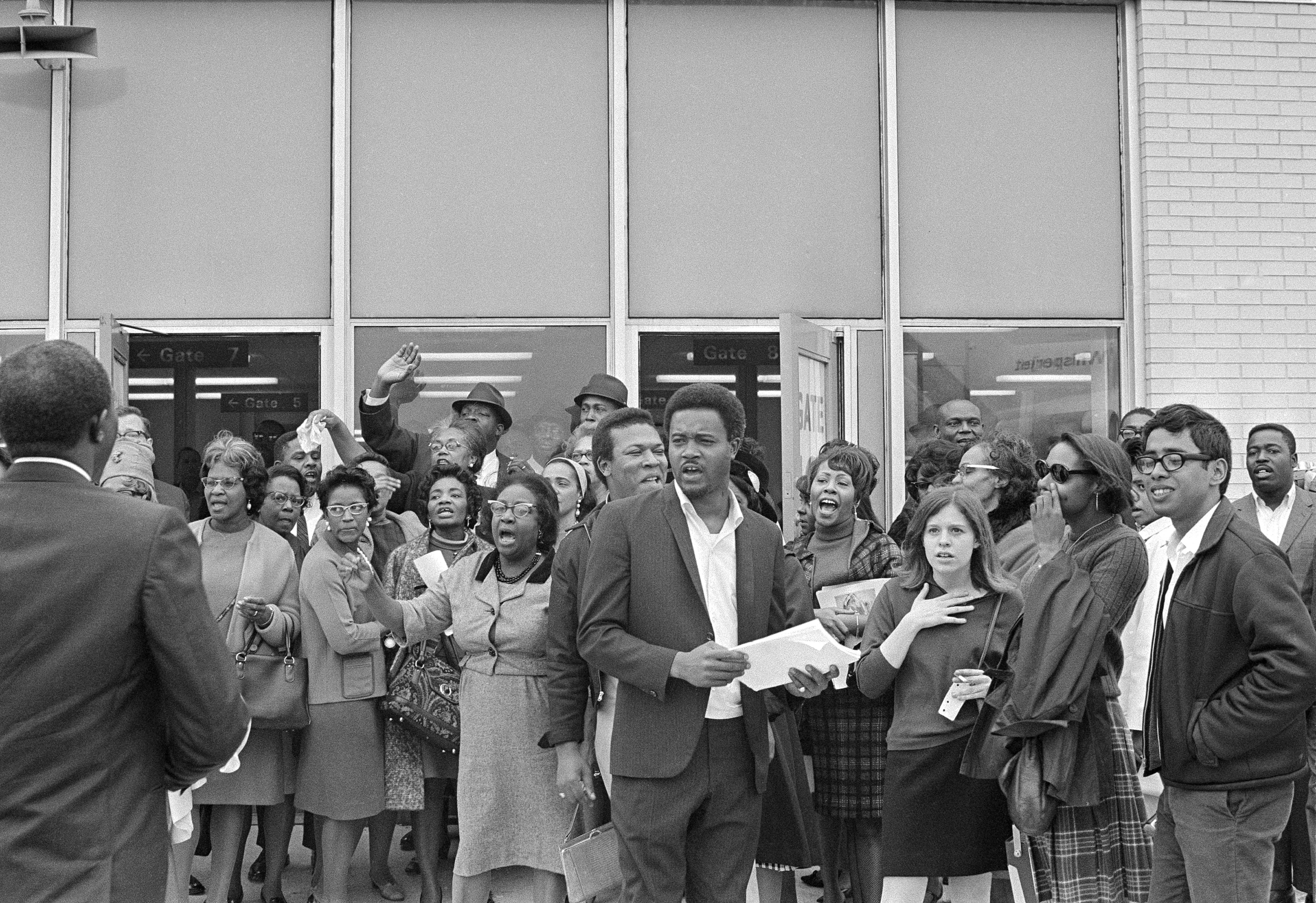 A number of supporters of Dr. Martin Luther Jr. gather at the Atlanta Airport, Oct. 30, 1967 to see King off on his trip to Birmingham, Ala., to serve a 5-day jail sentence. The group was lead by Hosea Williams, center, an official of King's Southern Christian Leadership Conference, who has promised to lead massive demonstrations in Birmingham while King is incarcerated.