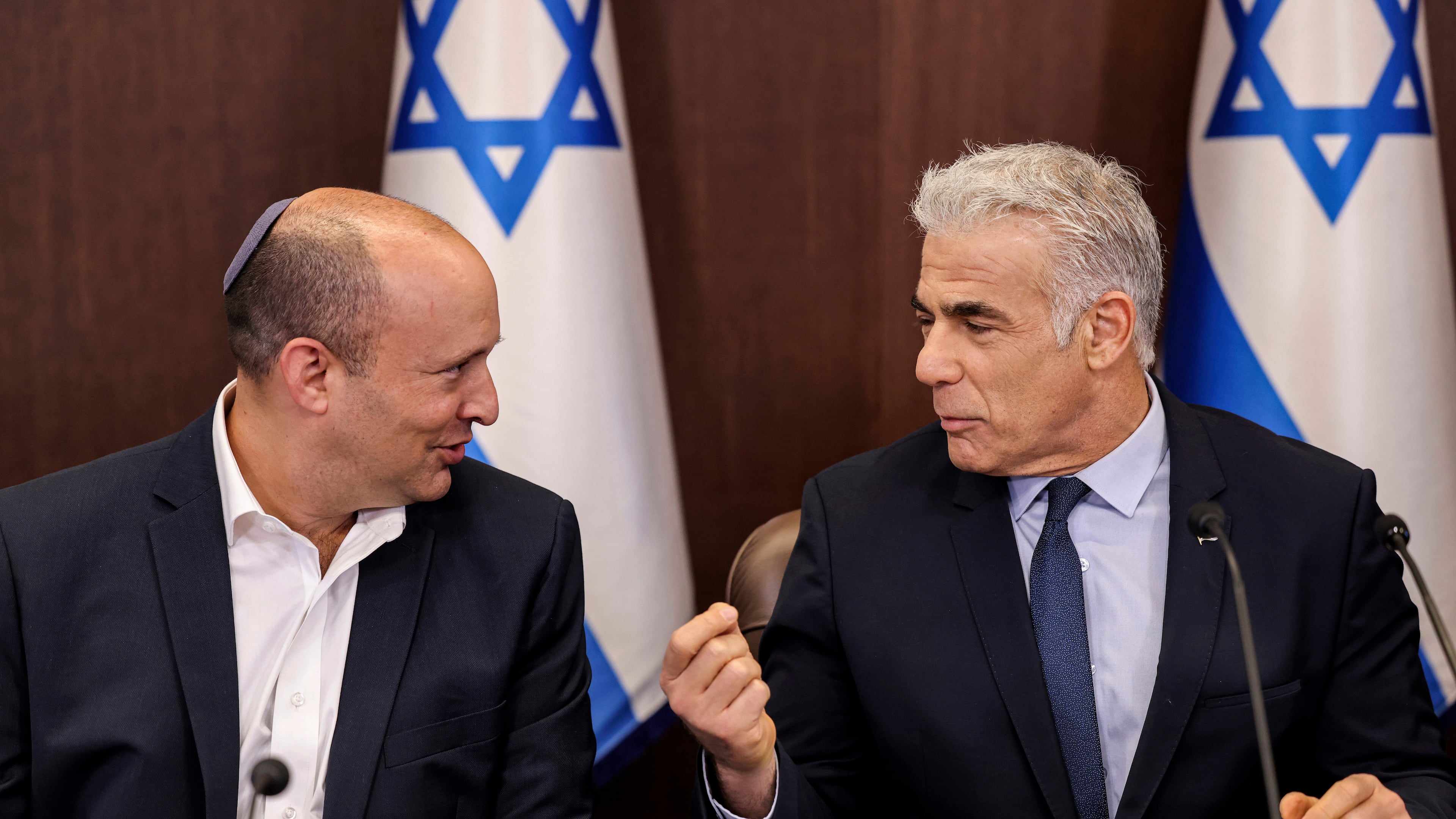 Israel's then caretaker Prime Minister Yair Lapid, right, talks with former Prime Minister Naftali Bennett during the weekly cabinet meeting in Jerusalem, on Sunday, Sept. 18, 2022. (Ronaldo Schemidt/Pool Photo via AP)