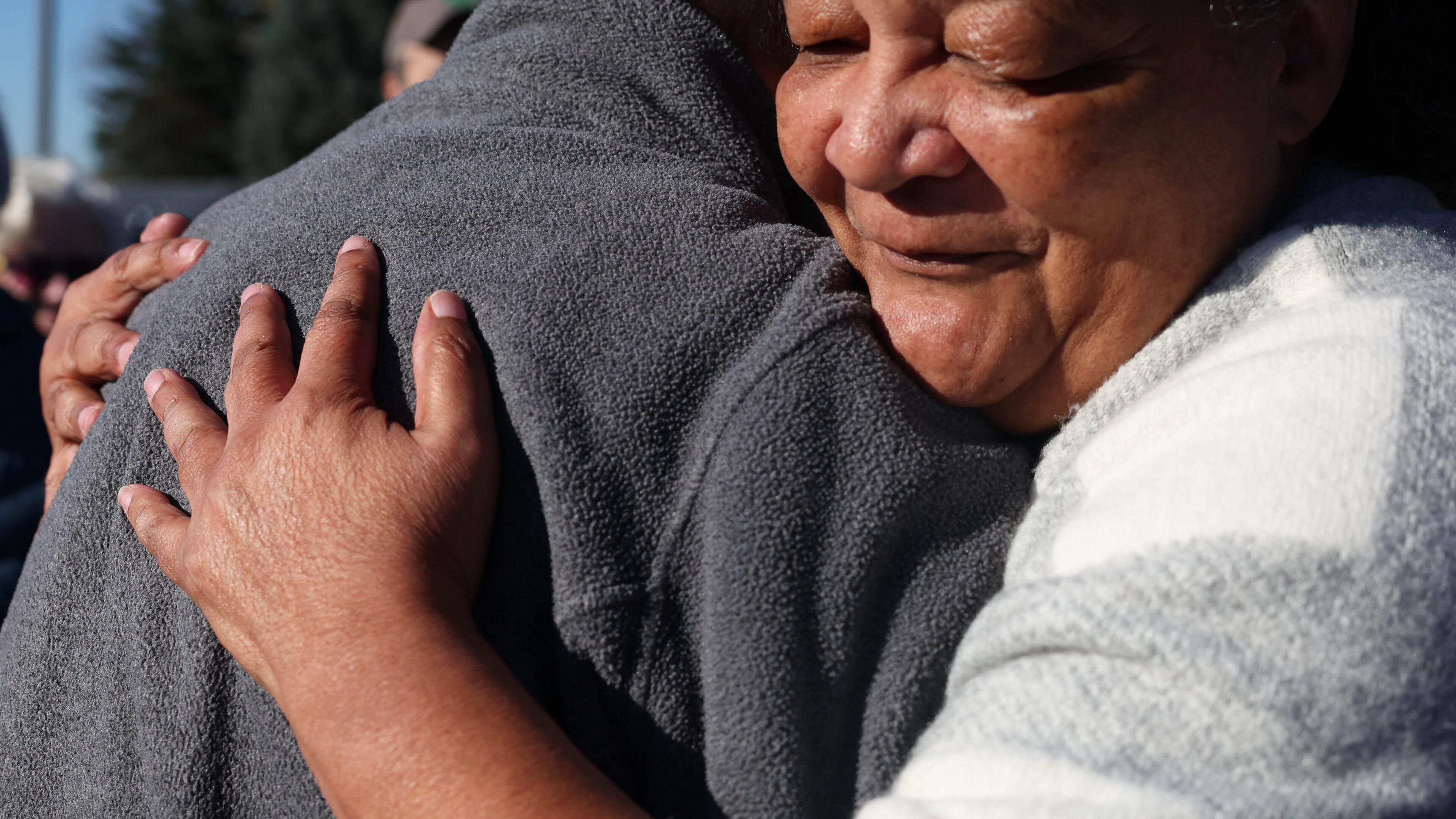 Rev. Fred Daley hugs Marva Cook, right, outside the U.S. Immigration and Customs Enforcement (ICE) office in Syracuse, N.Y., on Wednesday, Oct. 21, 2026. (Dennis Nett/The Post-Standard via AP)