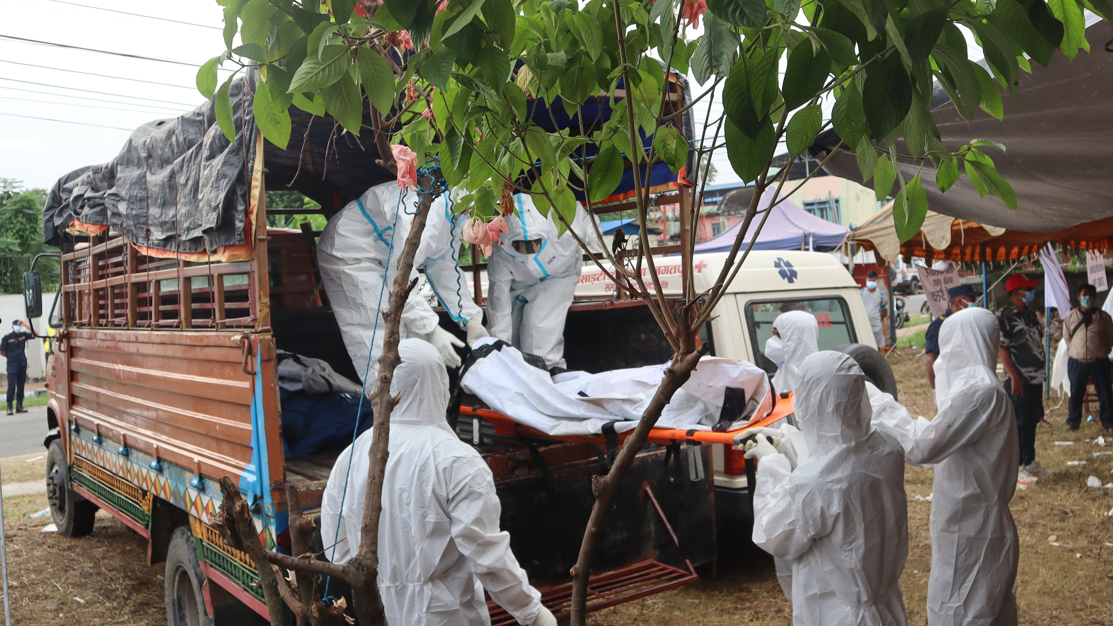 Rescuers carry bodies of flash flood victims for a mass burial in Chitwan, Nepal, Saturday, Aug. 29, 2026. (AP Photo/Nisha Shrestha)