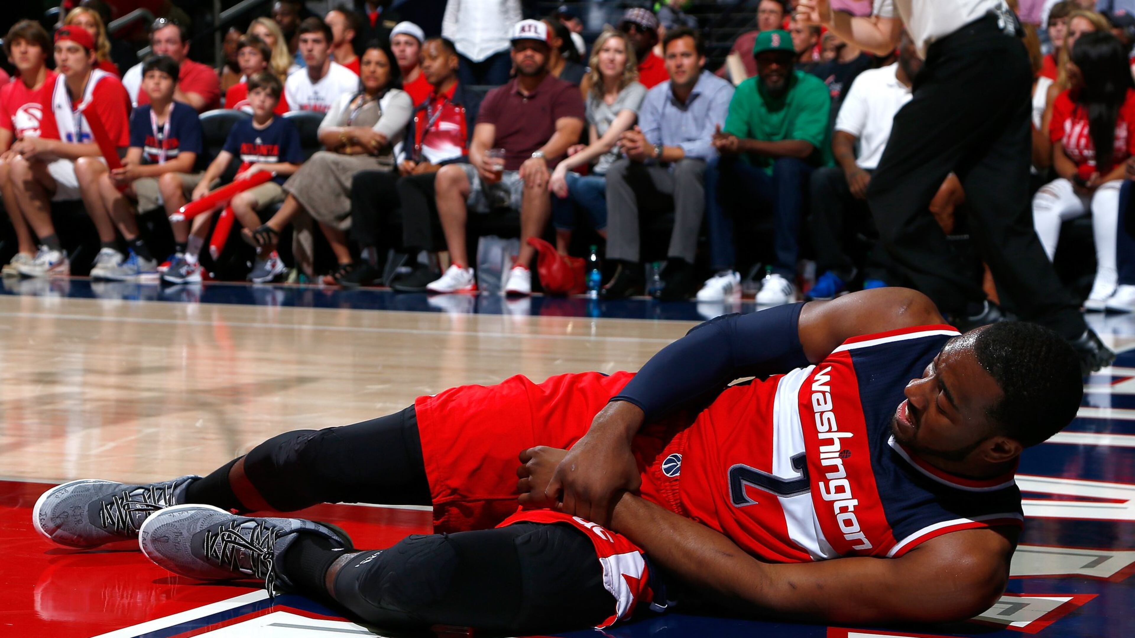 John Wall of the Wizards grabs his wrist after missing a basket and landing on the floor against the Hawks during Game 1 of their Eastern Conference semifinals series at Philips Arena on May 3. (Photo by Kevin C. Cox/Getty Images)