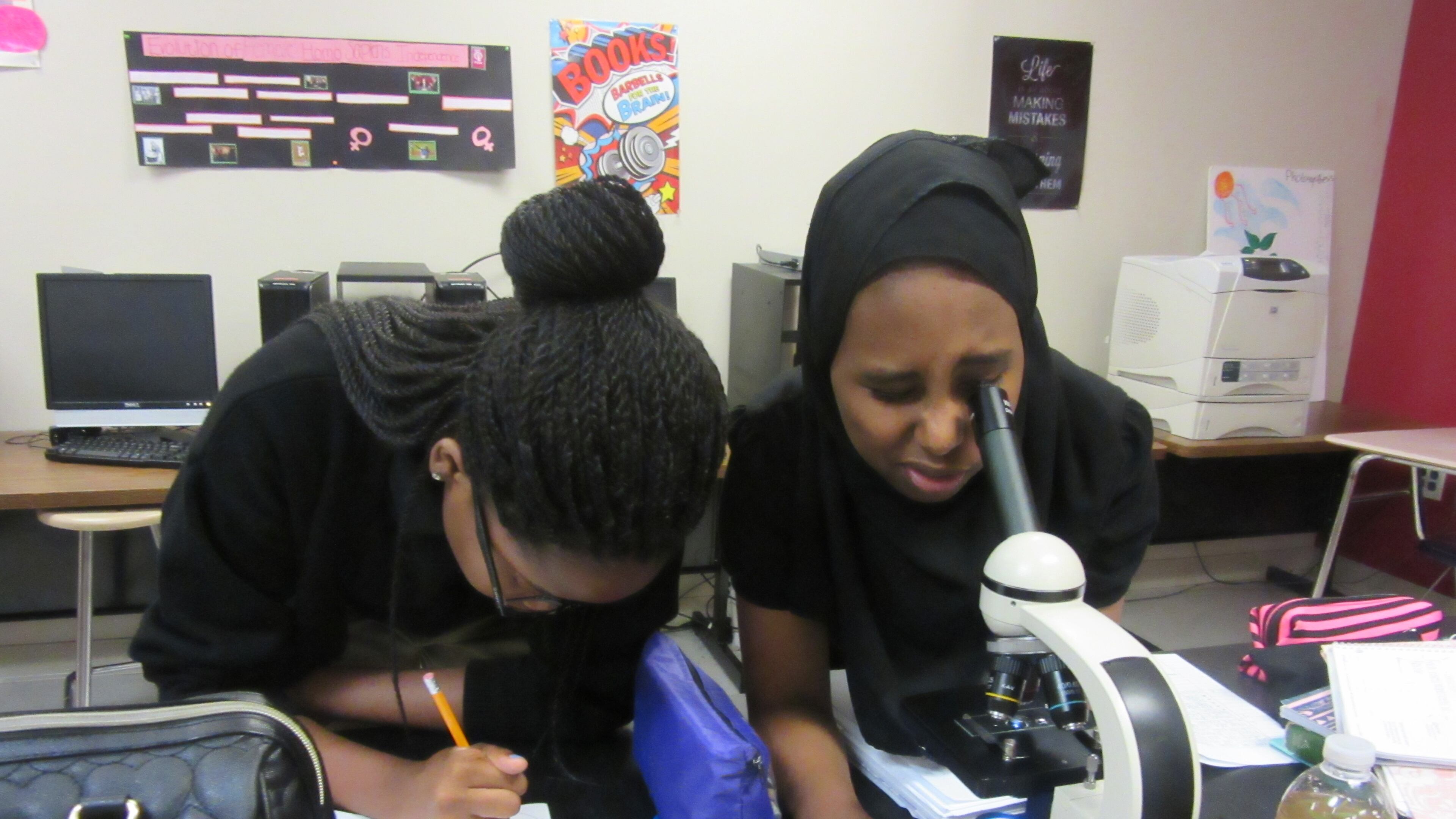 Sherifat Akinniyi (left) and Natoli Bora work in the science lab of the DeKalb Early College Academy in Stone Mountain. The school’s compressed course load allows students to enroll in college courses for their last two years of high school. Contributed.