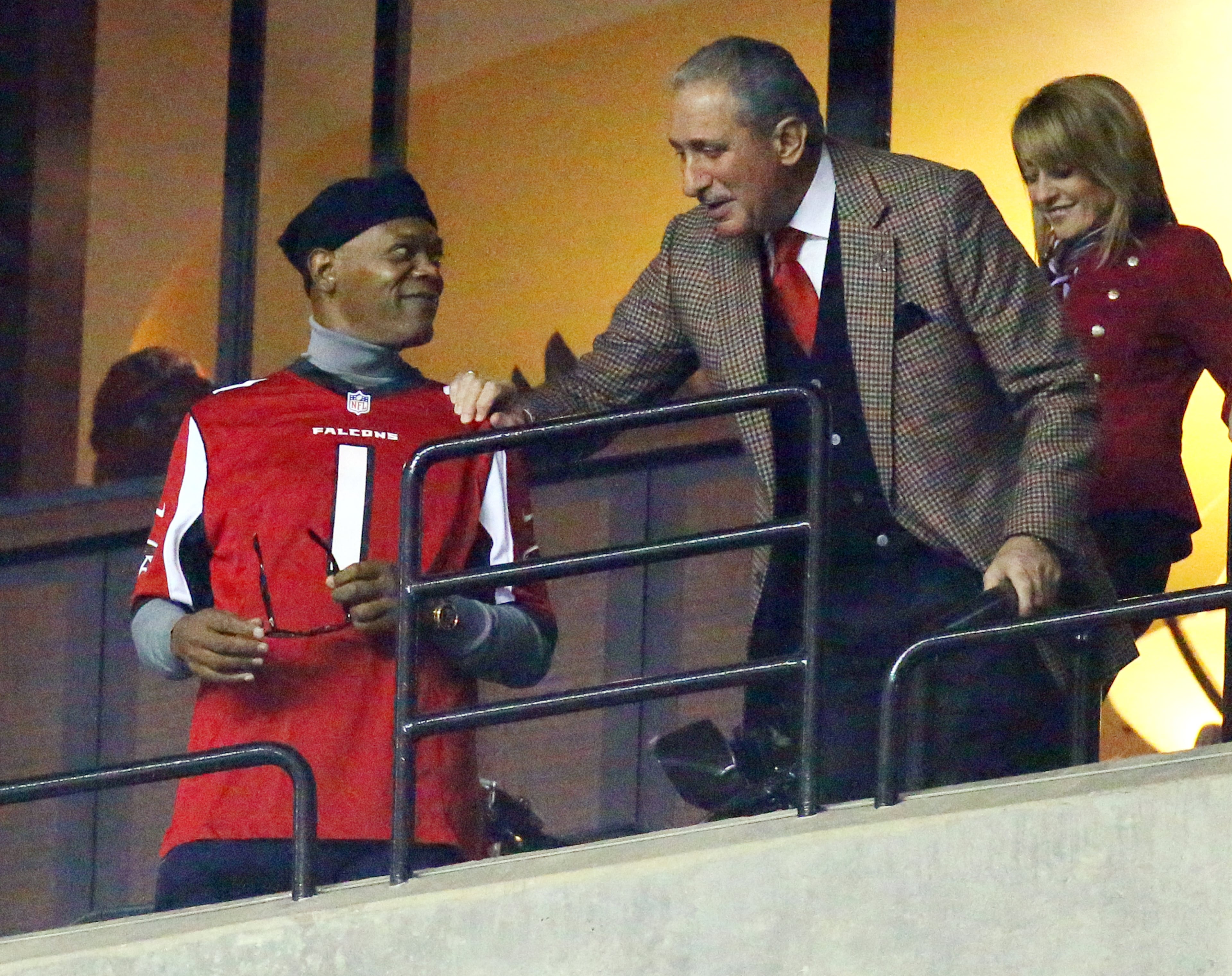 Falcons owner Arthur Blank and then-girlfriend Angie Macuga host actor Samuel L. Jackson in Blank'sbox during the first half of the Falcons and Saints NFL "Thursday Night Football" game on Nov. 21, 2013, in Atlanta. CURTIS COMPTON /staff CCOMPTON@AJC.COM
