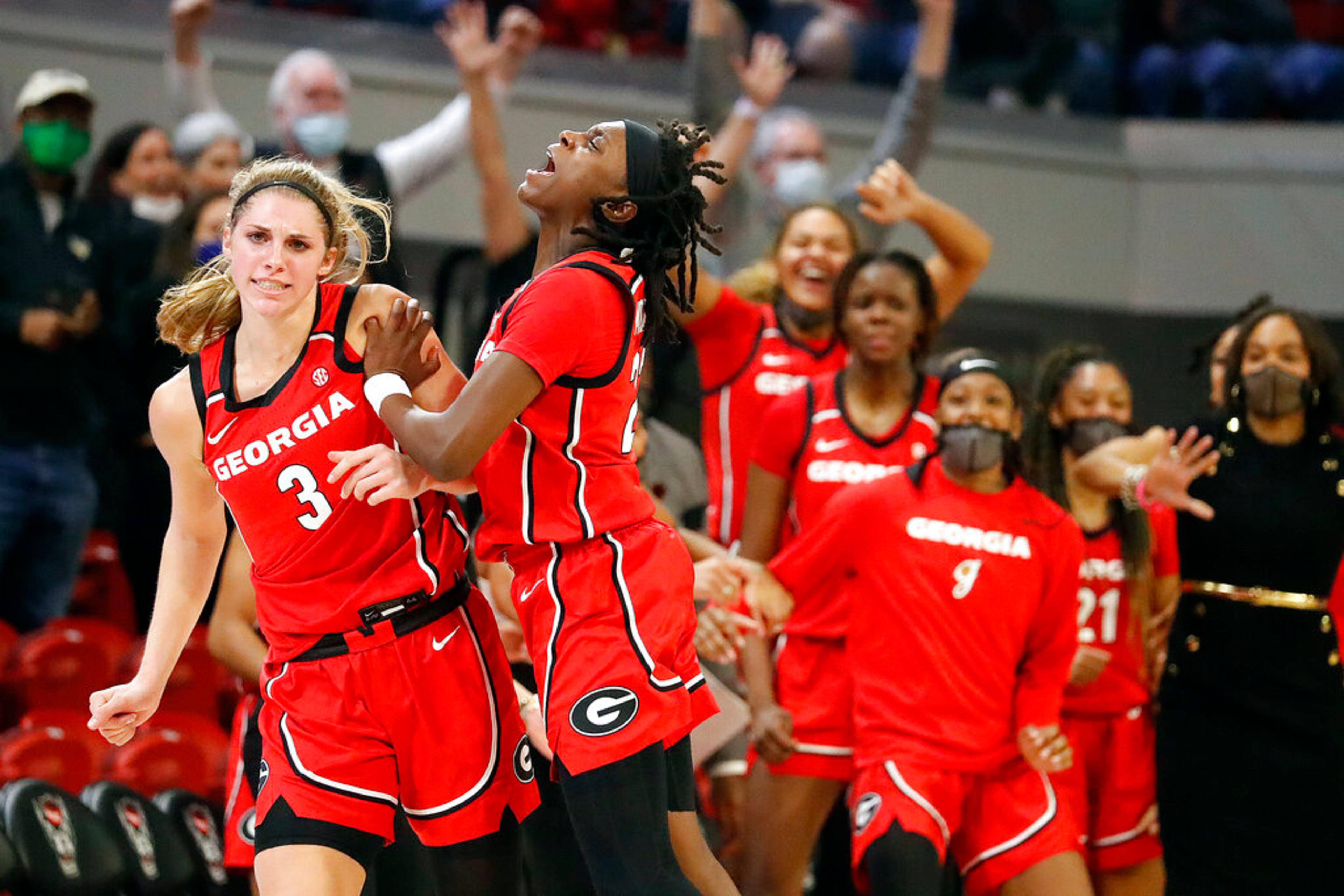Georgia's Sarah Ashlee Barker (3) celebrates with teammate Que Morrison (23) during the second half of an NCAA college basketball game against North Carolina State, Thursday, Dec. 16, 2021, in Raleigh, N.C. (AP Photo/Karl B. DeBlaker)
