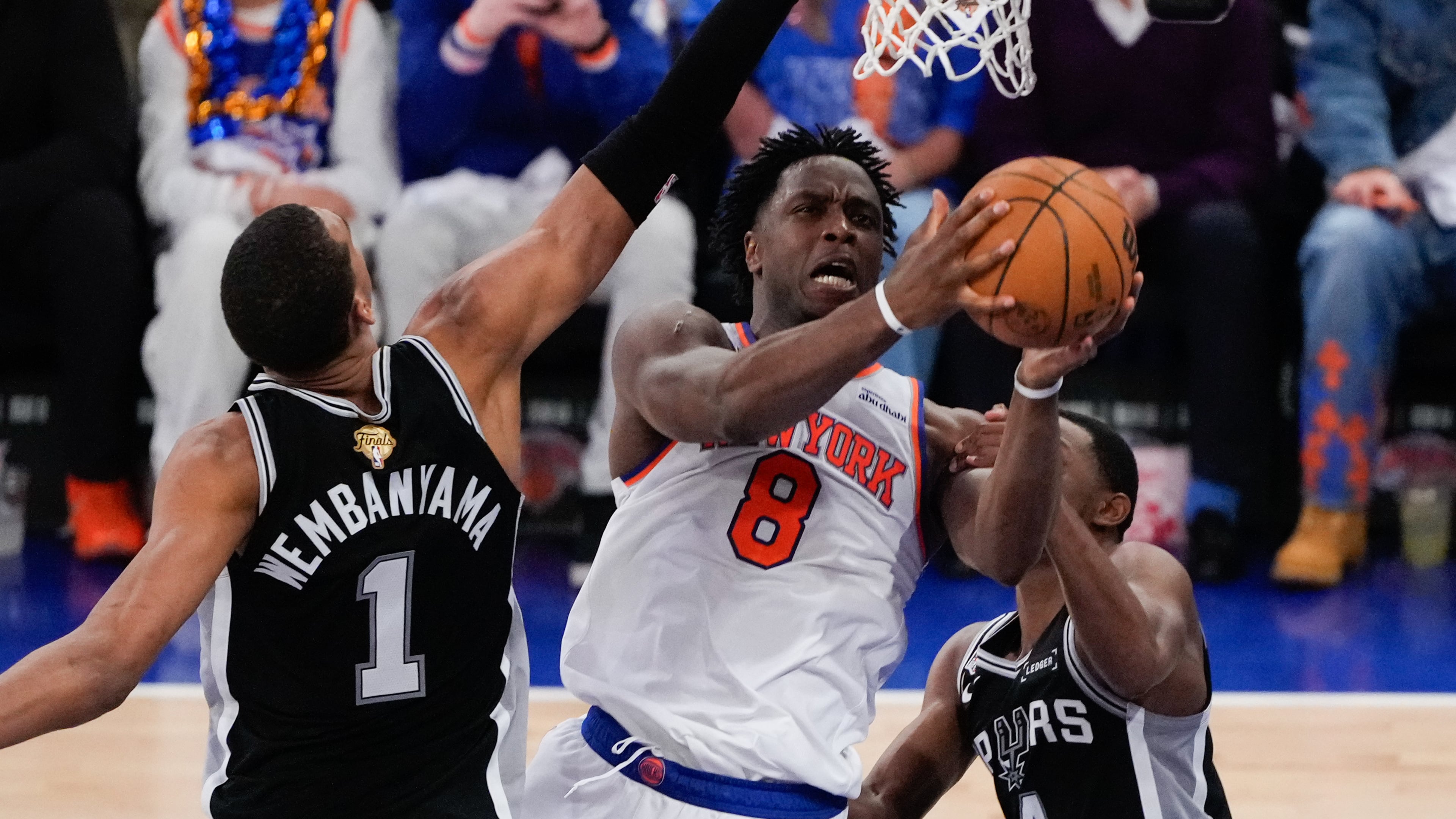 New York Knicks forward Og Anunoby (8) shoots between San Antonio Spurs forward Victor Wembanyama (1) and guard De'aaron Fox (4) during the first half of Game 4 of the NBA Finals basketball series, Wednesday, June 10, 2026, in New York. (AP Photo/Ross D. Franklin)